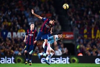 BARCELONA, SPAIN - NOVEMBER 01:  Sergio Busquets of FC Barcelona competes for the ball with Charles of Celta de Vigo the La Liga match between FC Barcelona and Celta de Vigo at Camp Nou on November 1, 2014 in Barcelona, Spain.  (Photo by David Ramos/Getty