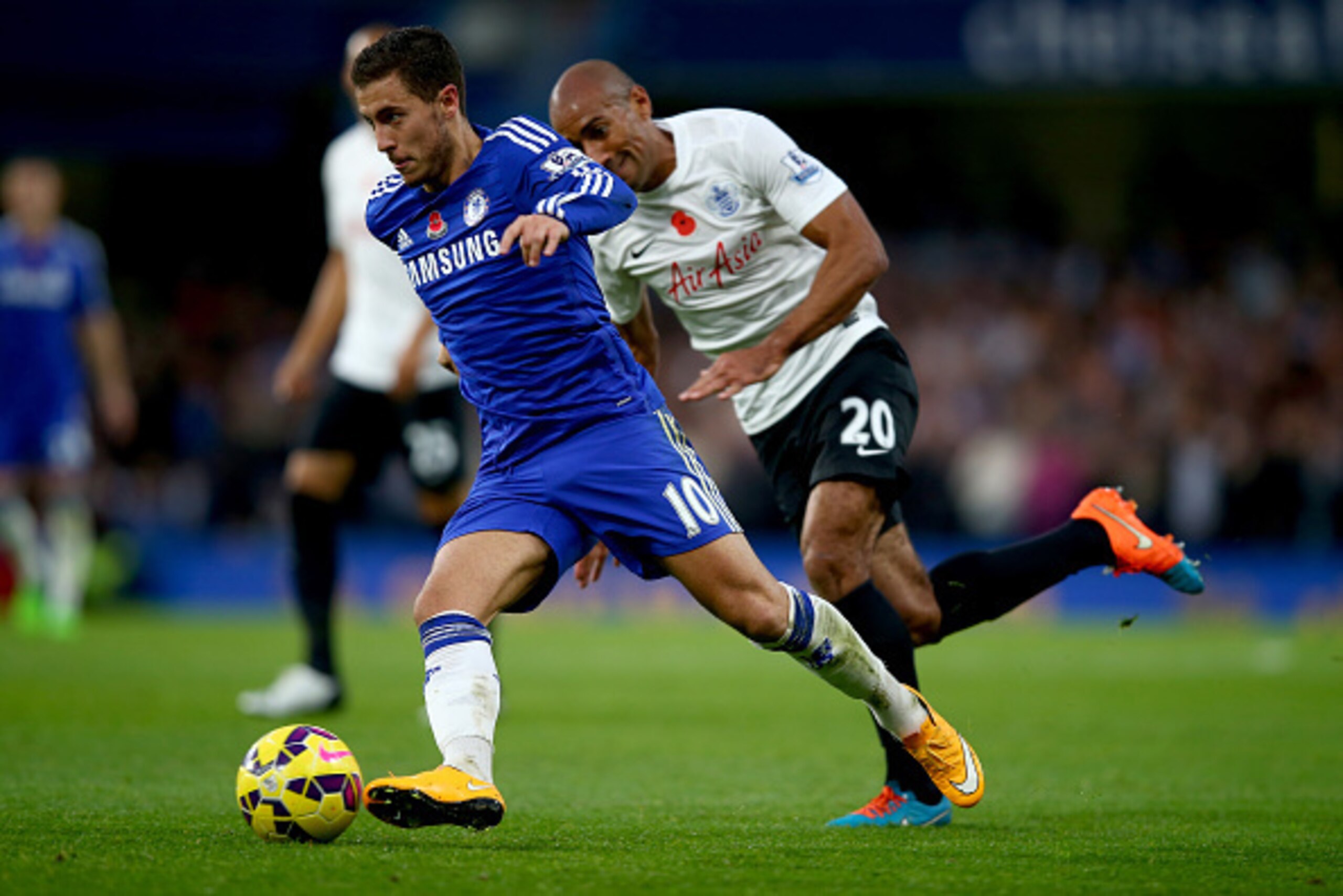 LONDON, ENGLAND - NOVEMBER 01:  Eden Hazard of Chelsea is tracked by Karl Henry of Queens Park Rangers during the Barclays Premier League match between Chelsea and Queens Park Rangers at Stamford Bridge on November 1, 2014 in London, England.  (Photo by C
