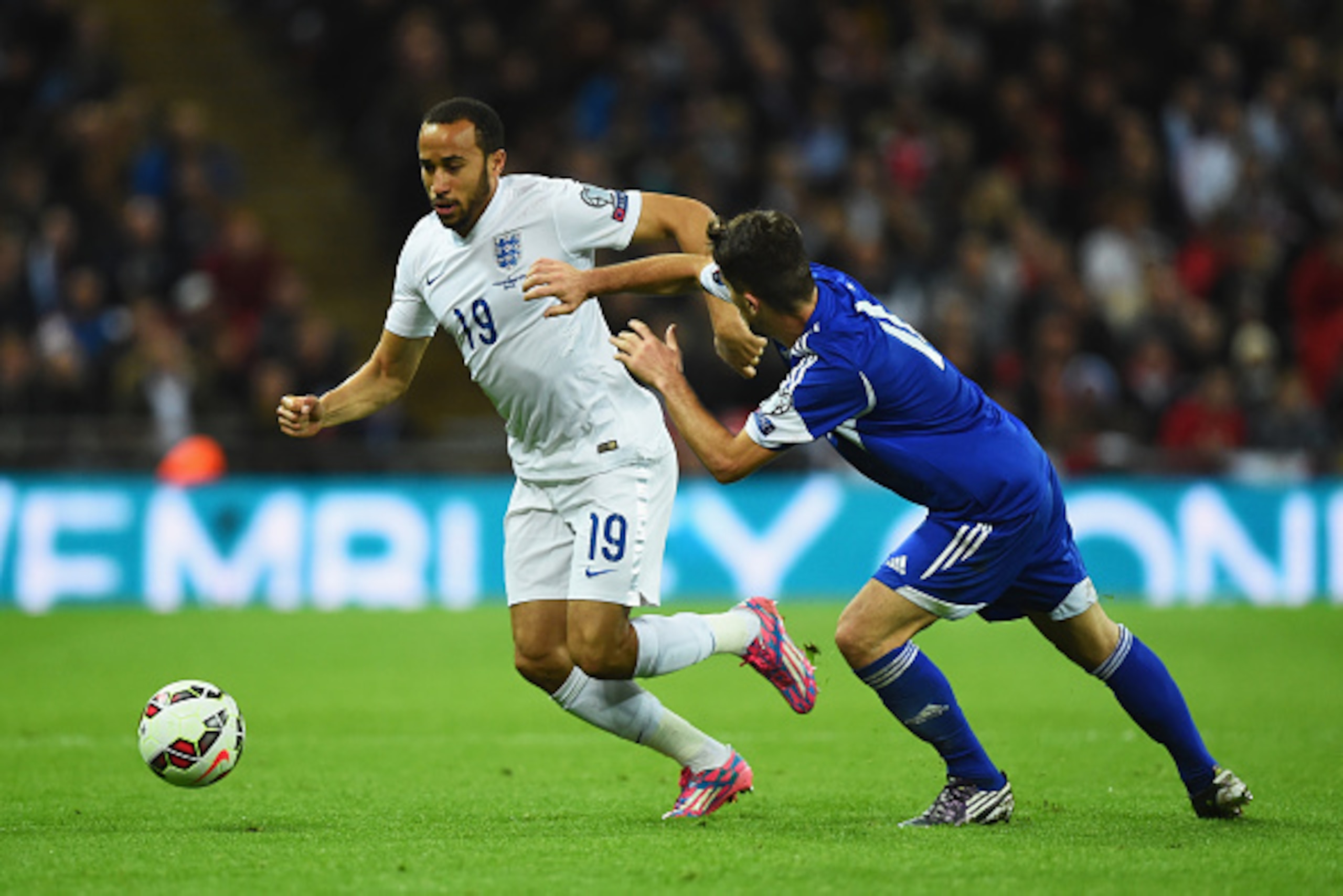 LONDON, ENGLAND - OCTOBER 09:  Andros Townsend of England holds off Matteo Vitaioli of San Marino during the EURO 2016 Group E Qualifying match between England and San Marino at Wembley Stadium on October 9, 2014 in London, England.  (Photo by Mike Hewitt