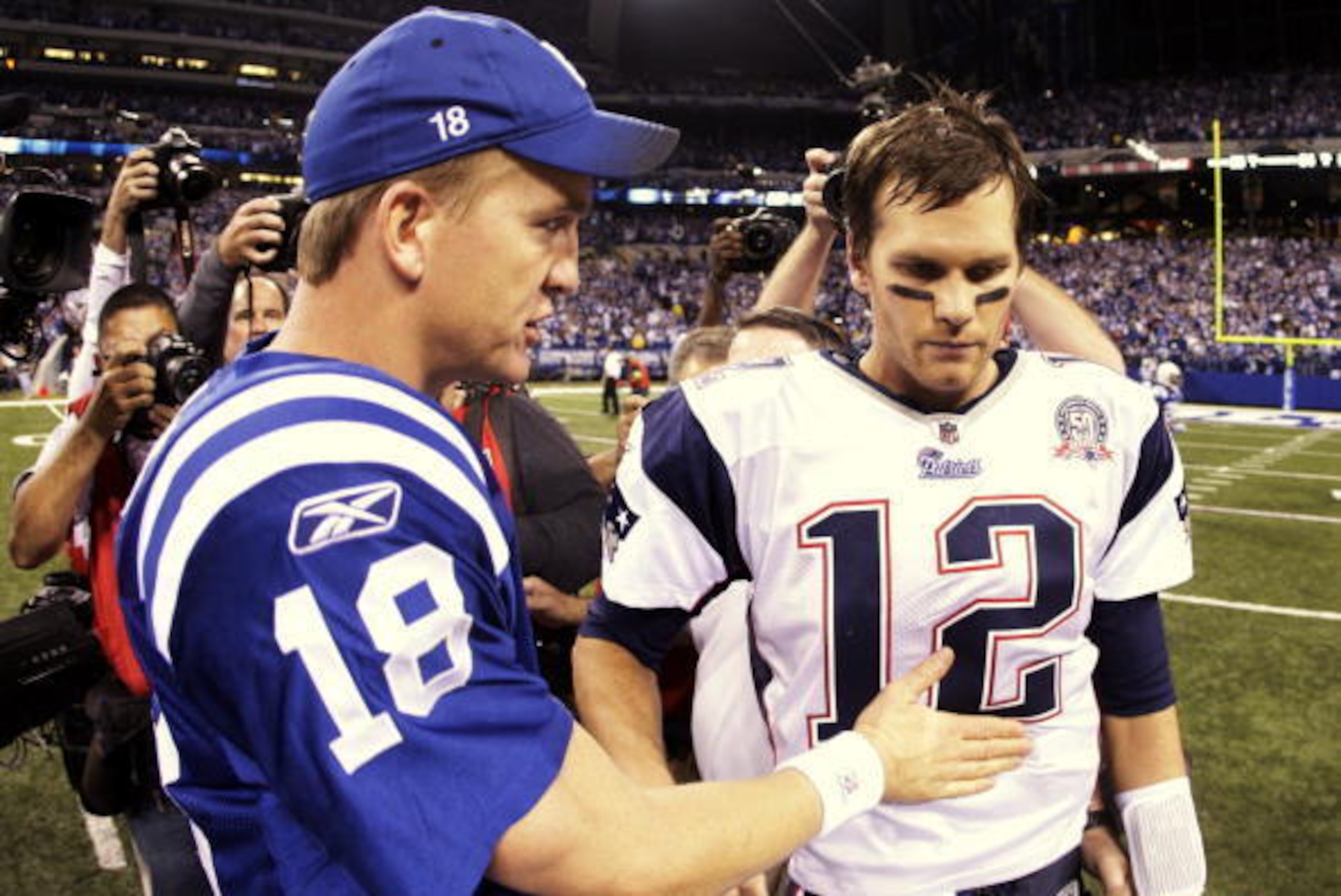 INDIANAPOLIS - NOVEMBER 15:  Quarterback Peyton Manning #18 of the Indianapolis Colts greets Tom Brady #12 of the New England Patriots after the game at Lucas Oil Stadium on November 15, 2009 in Indianapolis, Indiana.  The Colts won the game 35-34. (Photo