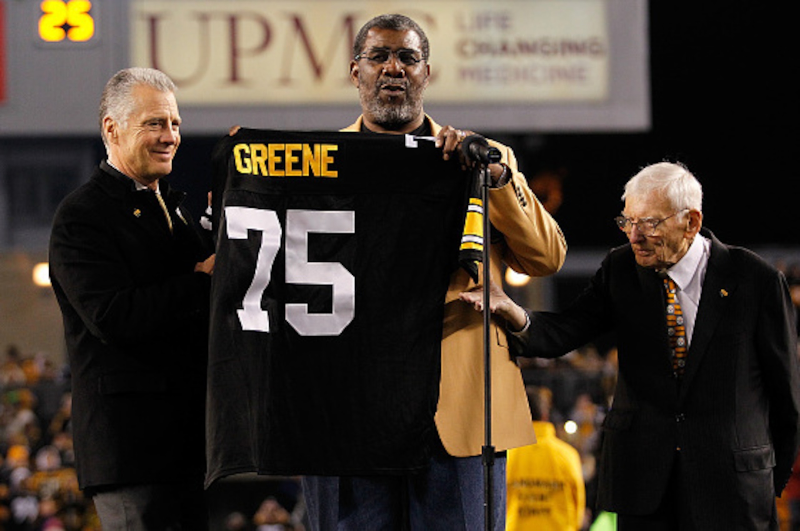 PITTSBURGH, PA - NOVEMBER 02:  Former Pittsburgh Steelers defensive tackle Joe Greene #75 has his number retired during a ceremony with Steelers President Art Rooney ll (L) and Chairman Dan Rooney (R) during halftime against the Baltimore Ravens at Heinz 