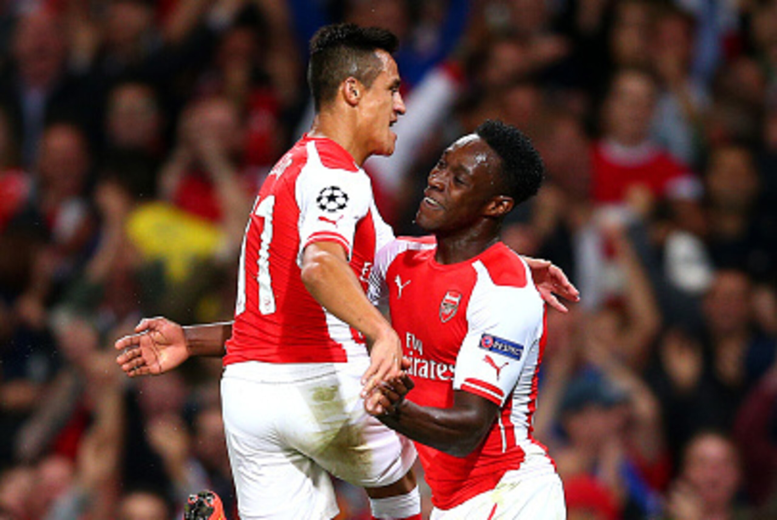 LONDON, ENGLAND - OCTOBER 01:  Danny Welbeck of Arsenal celebrates with team-mate Alexis Sanchez after scoring his team's second goal during the UEFA Champions League group D match between Arsenal FC and Galatasaray AS at Emirates Stadium on October 1, 20