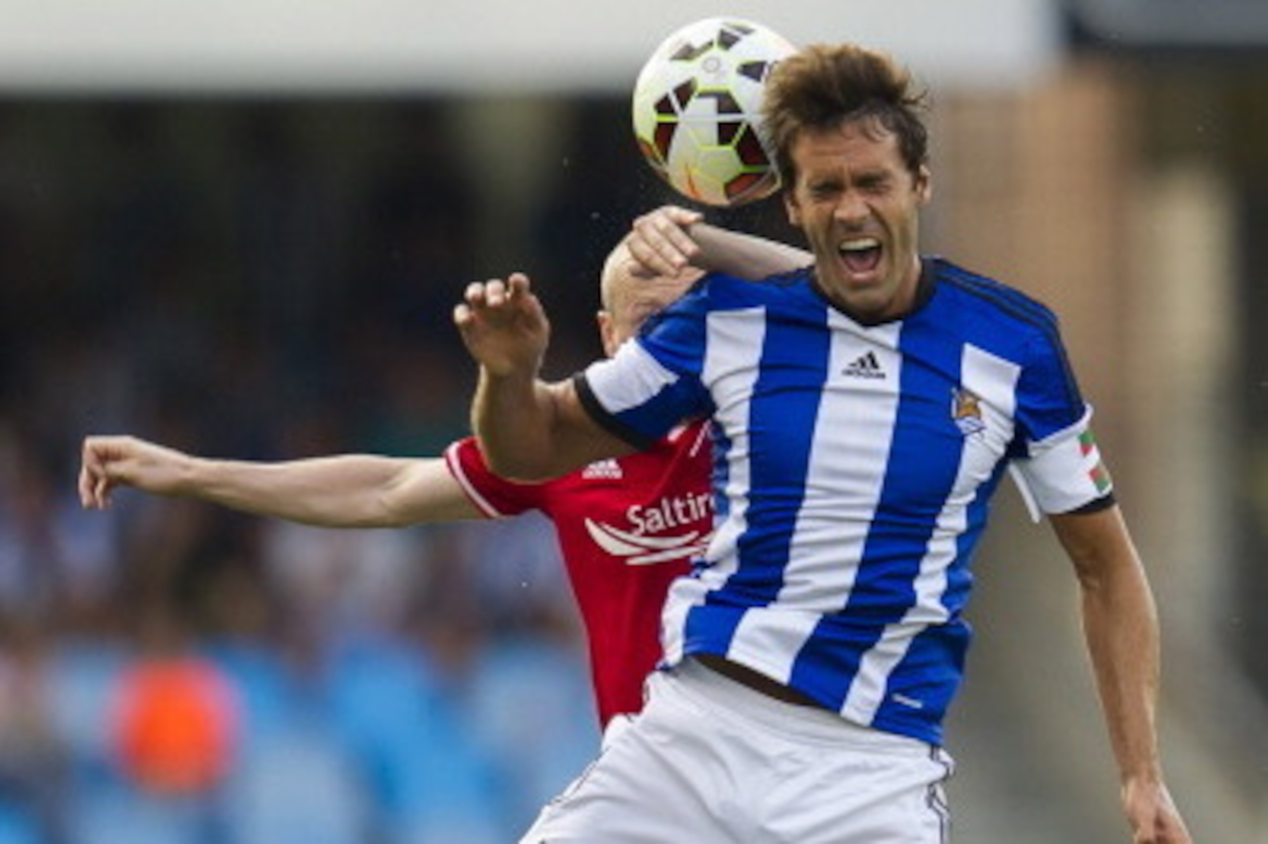 SAN SEBASTIAN, SPAIN - JULY 31: Willo Flood of Aberdeen CF duels for the ball with Xabi Prieto of Real Sociedad during the UEFA Europa League third round qualifying first leg match between Real Sociedad and Aberdeen FC at Estadio Anoeta on July 31, 2014 i
