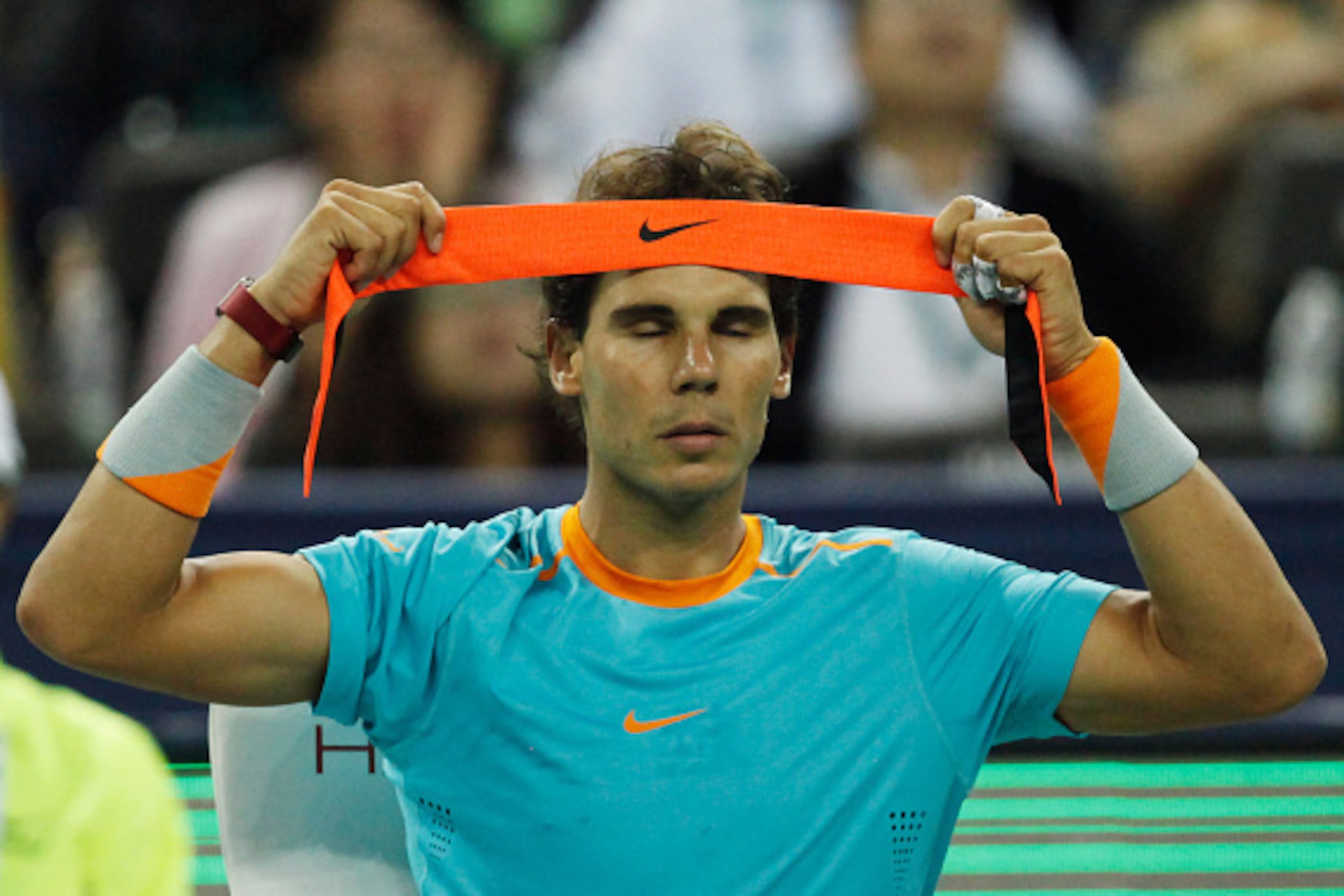 SHANGHAI, CHINA - OCTOBER 08: Rafael Nadal of Spain tie his hand band during his match against during day 4 of the Shanghai Rolex Masters at Zi Zhong stadium on October 8, 2014 in Shanghai, China. (Photo by Kevin Lee/Getty Images)