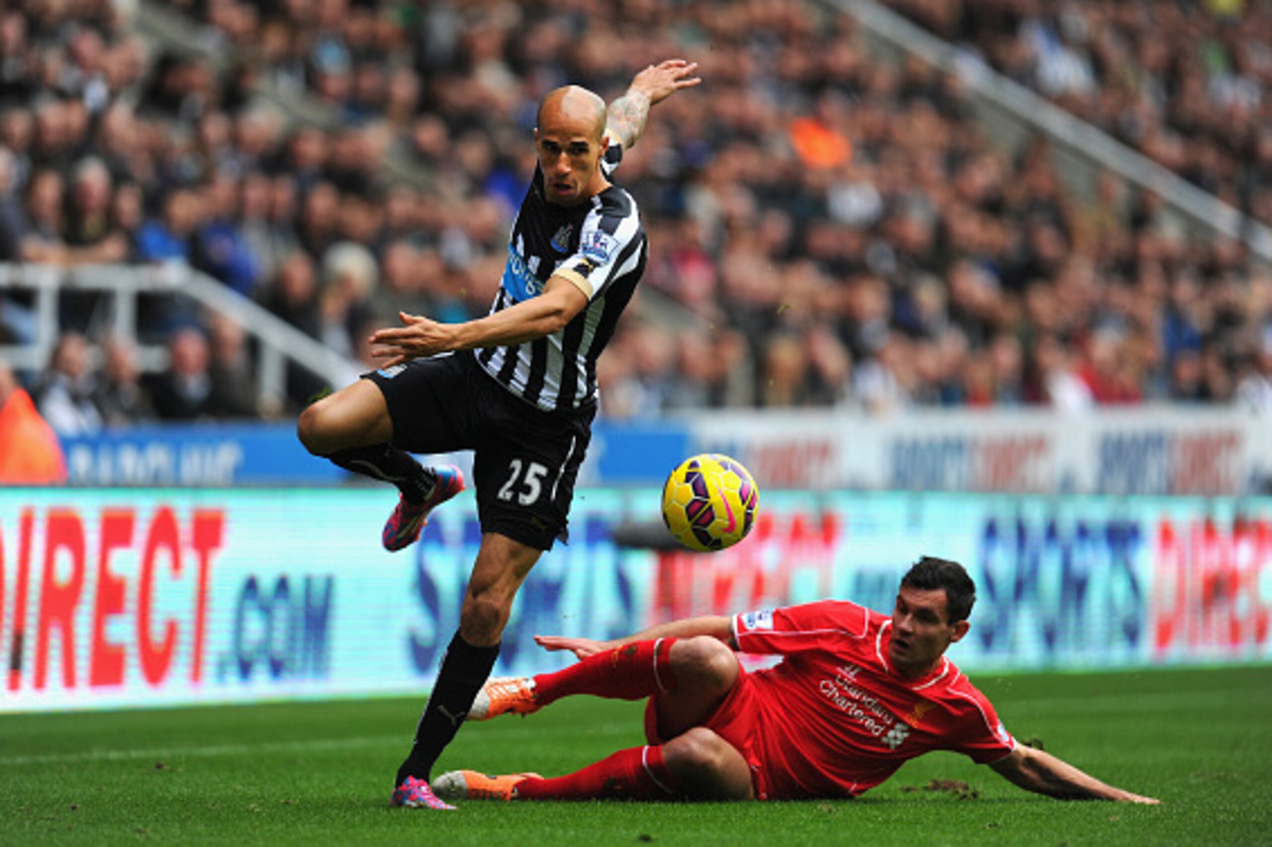 NEWCASTLE UPON TYNE, ENGLAND - NOVEMBER 01:  Newcastle player Gabriel Obertan skips the challenge of Dejan Lovren during the Barclays Premier League match between Newcastle United and Liverpool at St James' Park on November 1, 2014 in Newcastle upon Tyne,