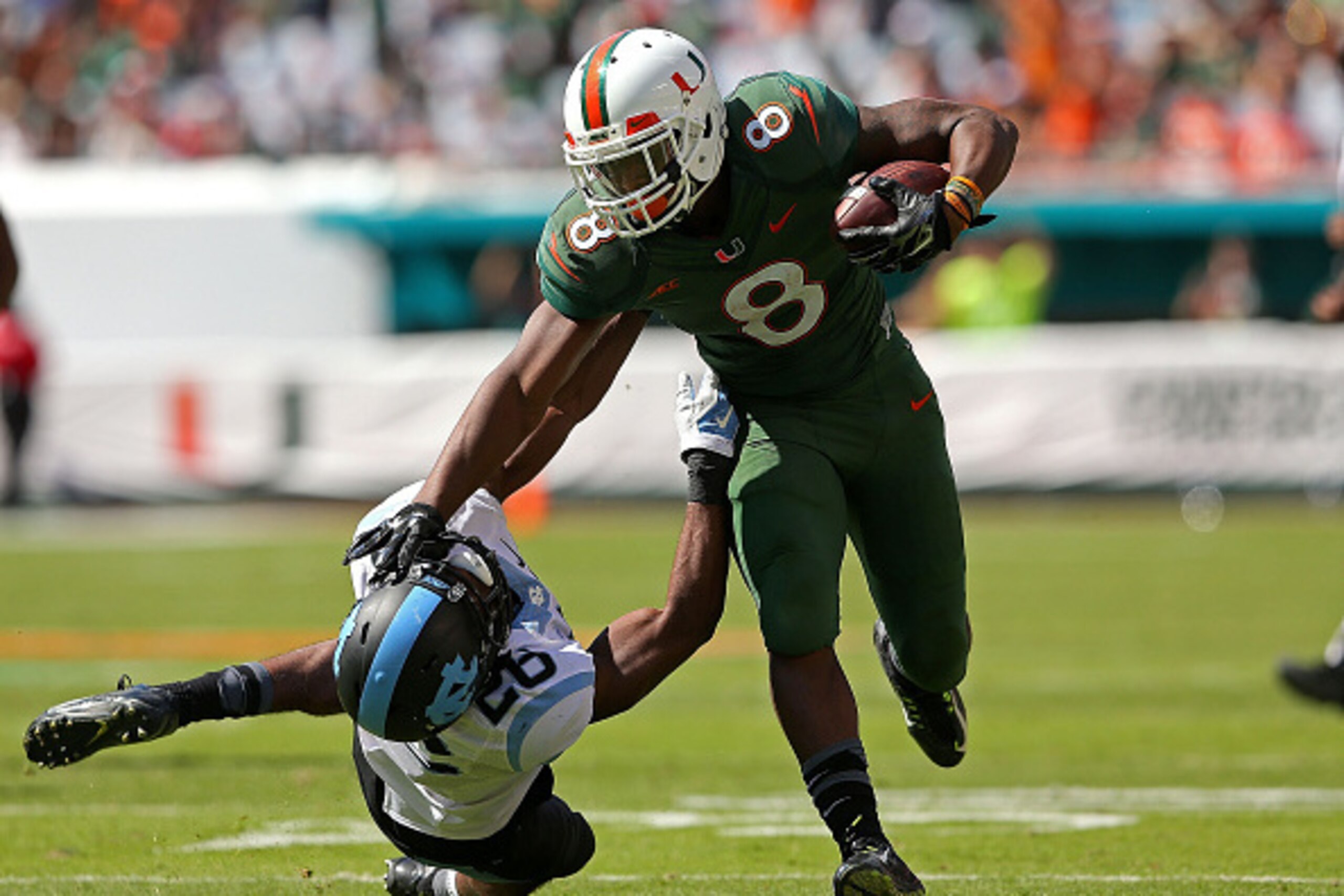 MIAMI GARDENS, FL - NOVEMBER 01:  Duke Johnson #8 of the Miami Hurricanes rushes for a first down during a game against the North Carolina Tar Heels at Sun Life Stadium on November 1, 2014 in Miami Gardens, Florida.  (Photo by Mike Ehrmann/Getty Images)