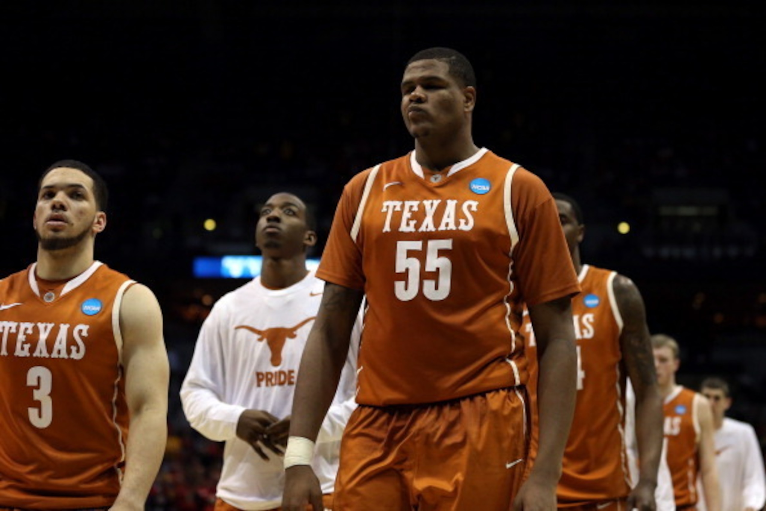 MILWAUKEE, WI - MARCH 22:  Javan Felix #3 and Cameron Ridley #55 of the Texas Longhorns walks off court after being defeated by the Michigan Wolverines during the third round of the 2014 NCAA Men's Basketball Tournament at BMO Harris Bradley Center on Mar
