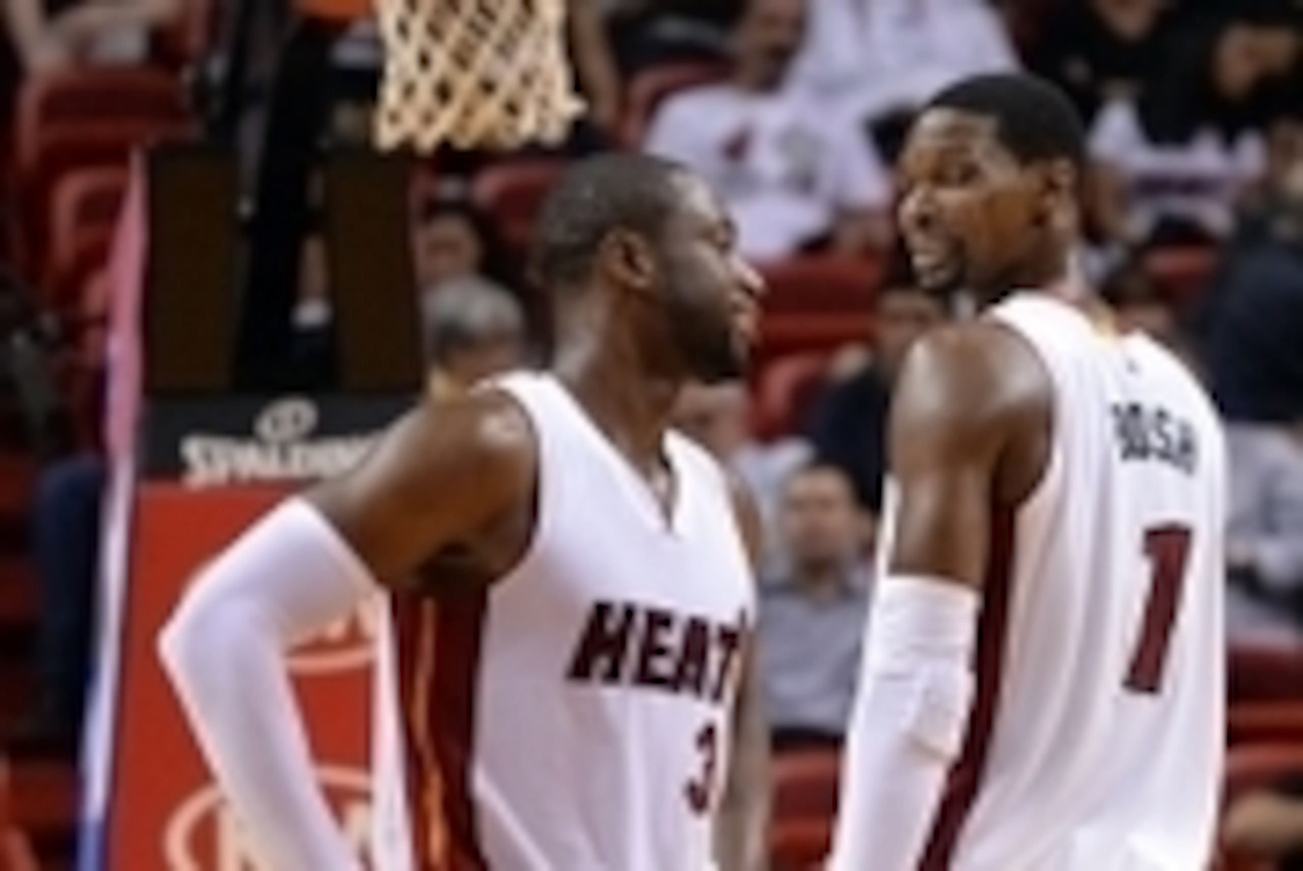 Oct 14, 2014; Miami, FL, USA; Miami Heat forward Chris Bosh (right) talks with guard Dwyane Wade (left) during the second half against the Atlanta Hawks at American Airlines Arena. Mandatory Credit: Steve Mitchell-USA TODAY Sports