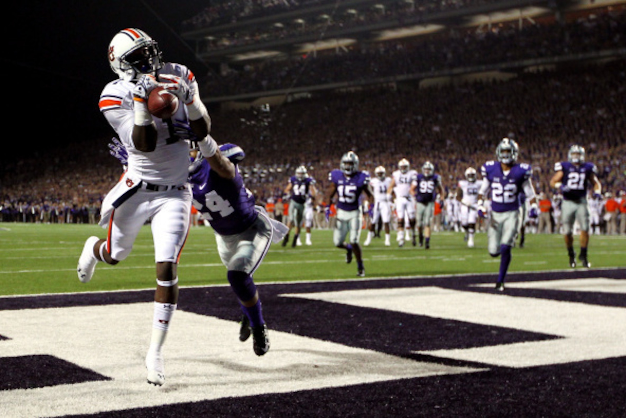 MANHATTAN, KS - SEPTEMBER 18:  Wide receiver D'haquille Williams #1 of the Auburn Tigers makes a catch in the endzone for a touchdown as defensive back Nate Jackson #24 of the Kansas State Wildcats defends during the game at Bill Snyder Family Football St