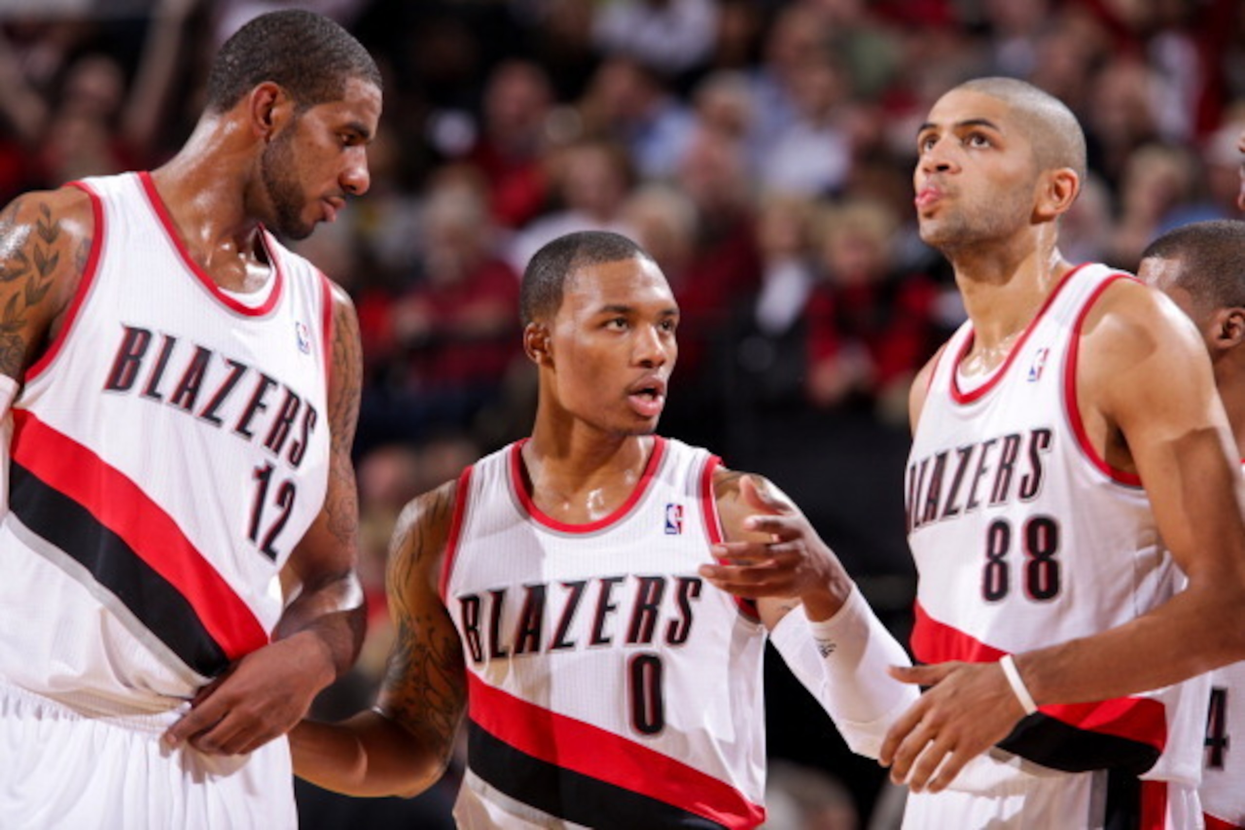 PORTLAND, OR - NOVEMBER 8: Damian Lillard #0 of the Portland Trail Blazers speaks to teammates LaMarcus Aldridge #12 and Nicolas Batum #88 before resuming action against the Los Angeles Clippers on November 8, 2012 at the Rose Garden Arena in Portland, Or