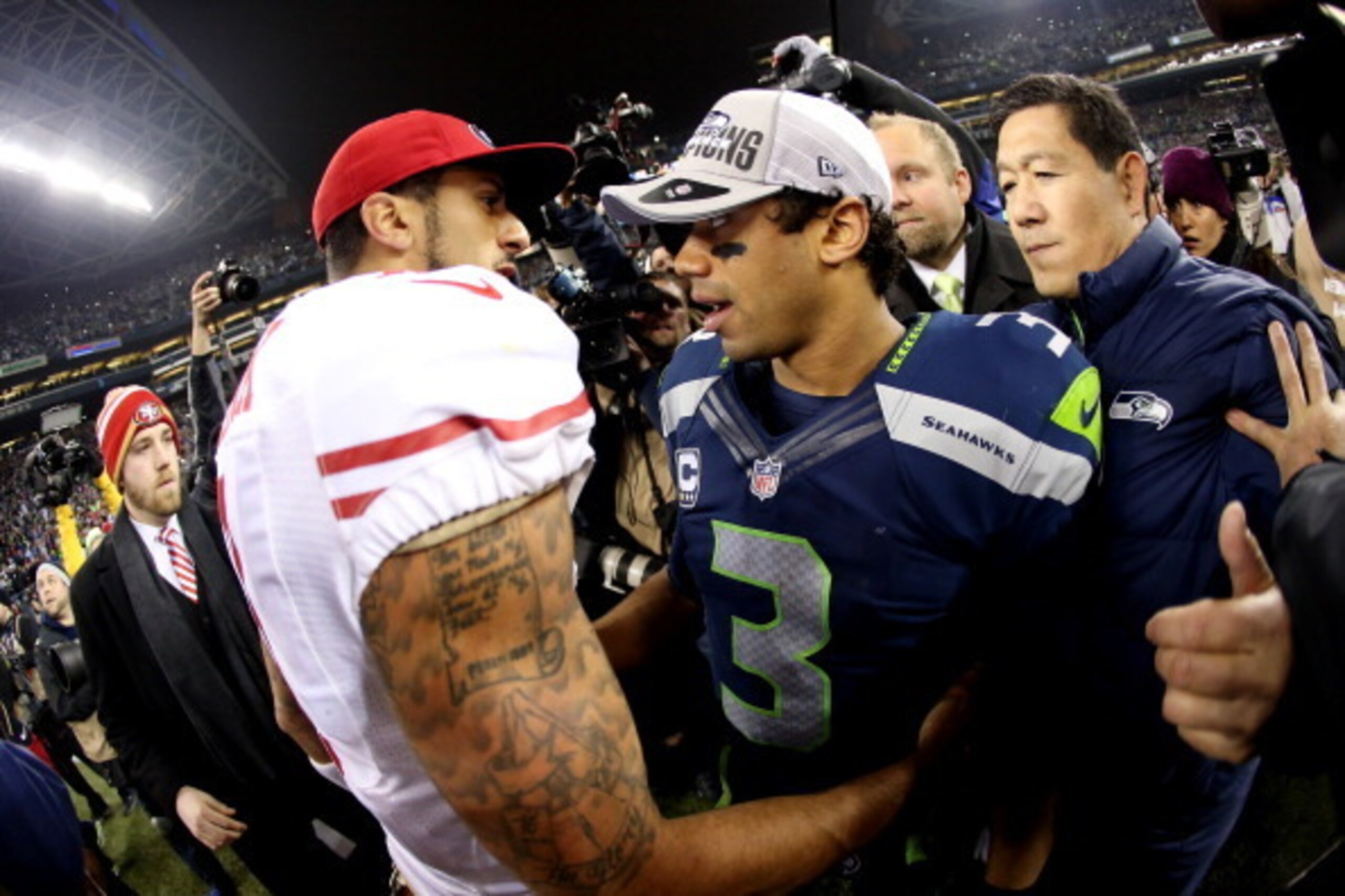 SEATTLE, WA - JANUARY 19:  Quarterback Colin Kaepernick #7 of the San Francisco 49ers shakes hands with quarterback Russell Wilson #3 of the Seattle Seahawks after the Seahawks defeated the 49ers 23-17 during the 2014 NFC Championship at CenturyLink Field