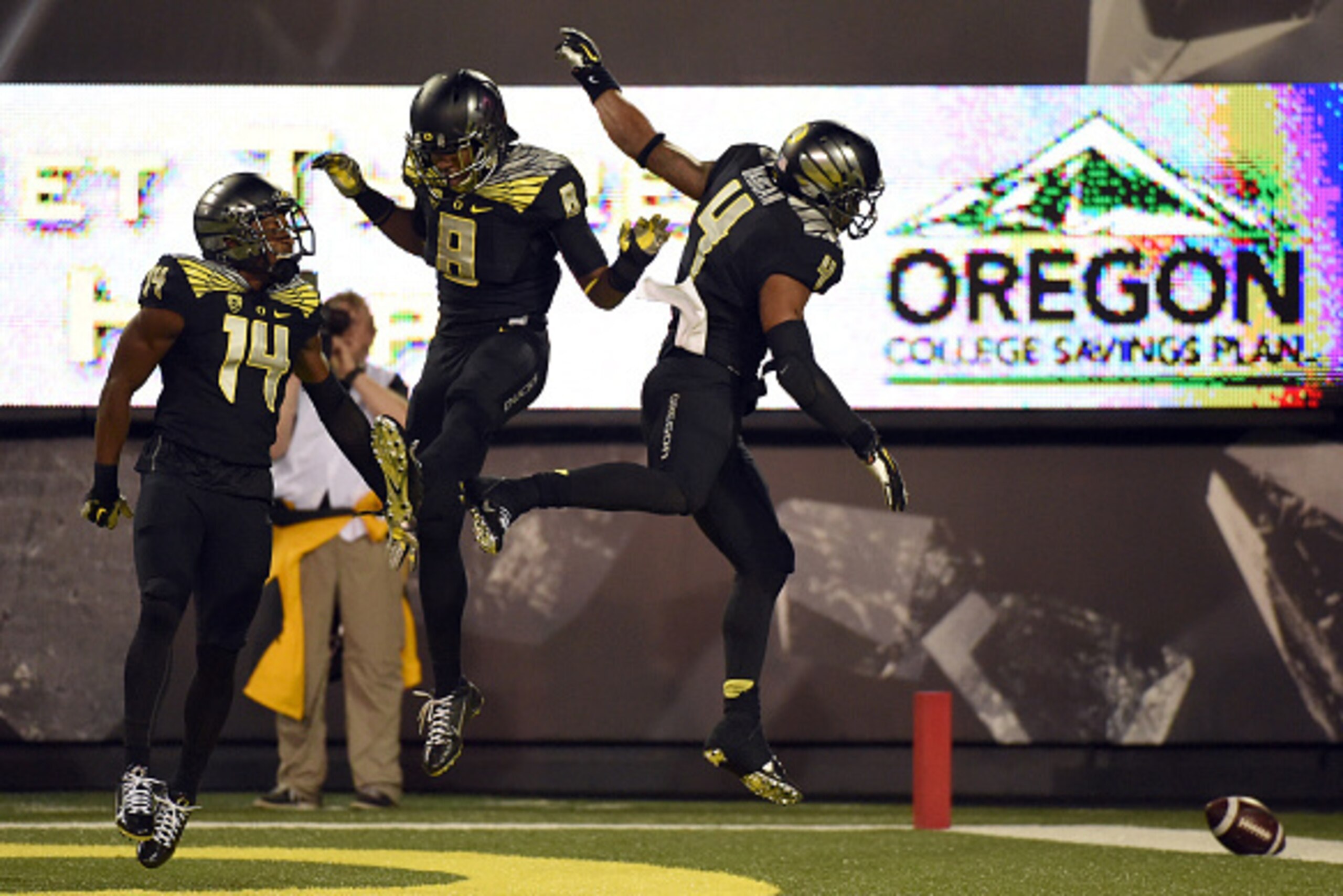 EUGENE, OR - NOVEMBER 1: Defensive back Ifo Ekpre-Olomu #14, defensive back Reggie Daniels #8 and defensive back Erick Dargan #4 of the Oregon Ducks celebrate Dargan's interception during the third quarter of the game against the Stanford Cardinal at Autz