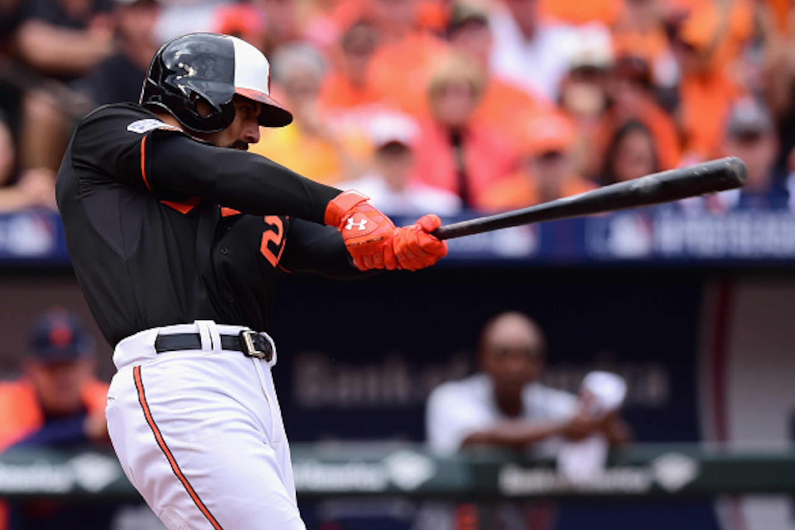 BALTIMORE, MD - OCTOBER 03:  Nick Markakis #21 of the Baltimore Orioles hits a two run home run to right field scoring teammate Jonathan Schoop #6 in the third inning against Justin Verlander #35 of the Detroit Tigers during Game Two of the American Leagu