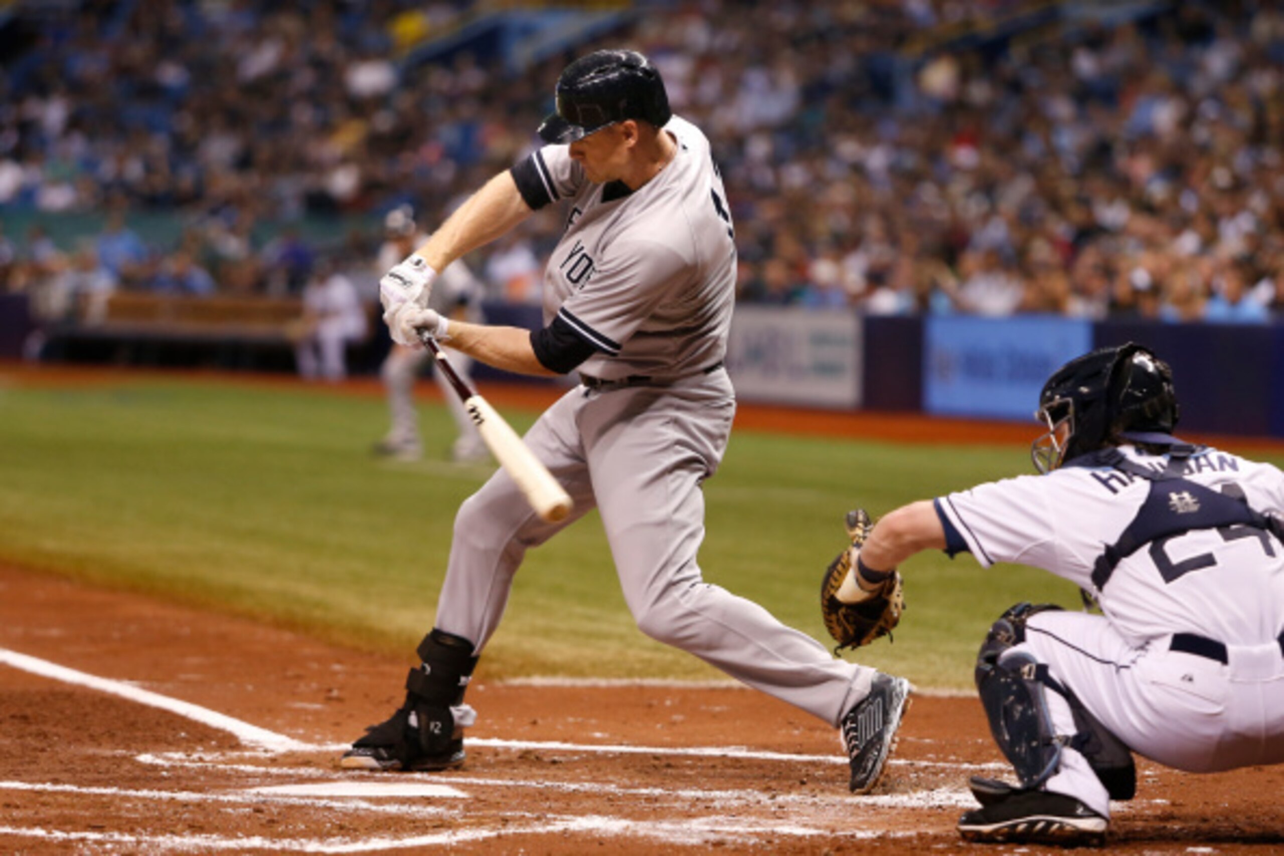 ST. PETERSBURG, FL - SEPTEMBER 17:  Chase Headley #12 of the New York Yankees strikes out swinging in front of catcher Ryan Hanigan #24 of the Tampa Bay Rays during the third inning of a game on September 17, 2014 at Tropicana Field in St. Petersburg, Flo