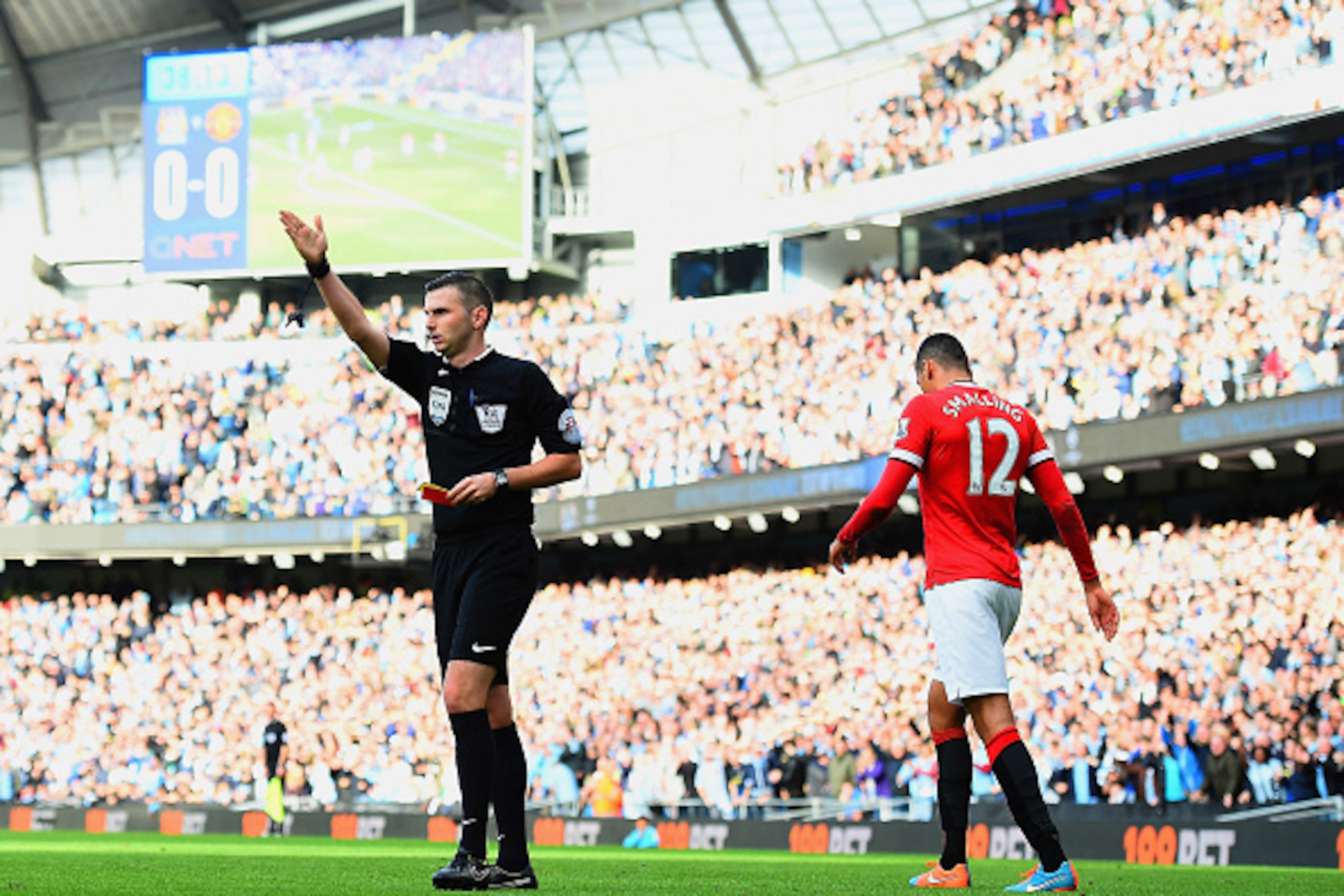 MANCHESTER, ENGLAND - NOVEMBER 02:  Chris Smalling of Manchester United leaves the field after receiving a red card by Referee Michael Oliver during the Barclays Premier League match between Manchester City and Manchester United at Etihad Stadium on Novem