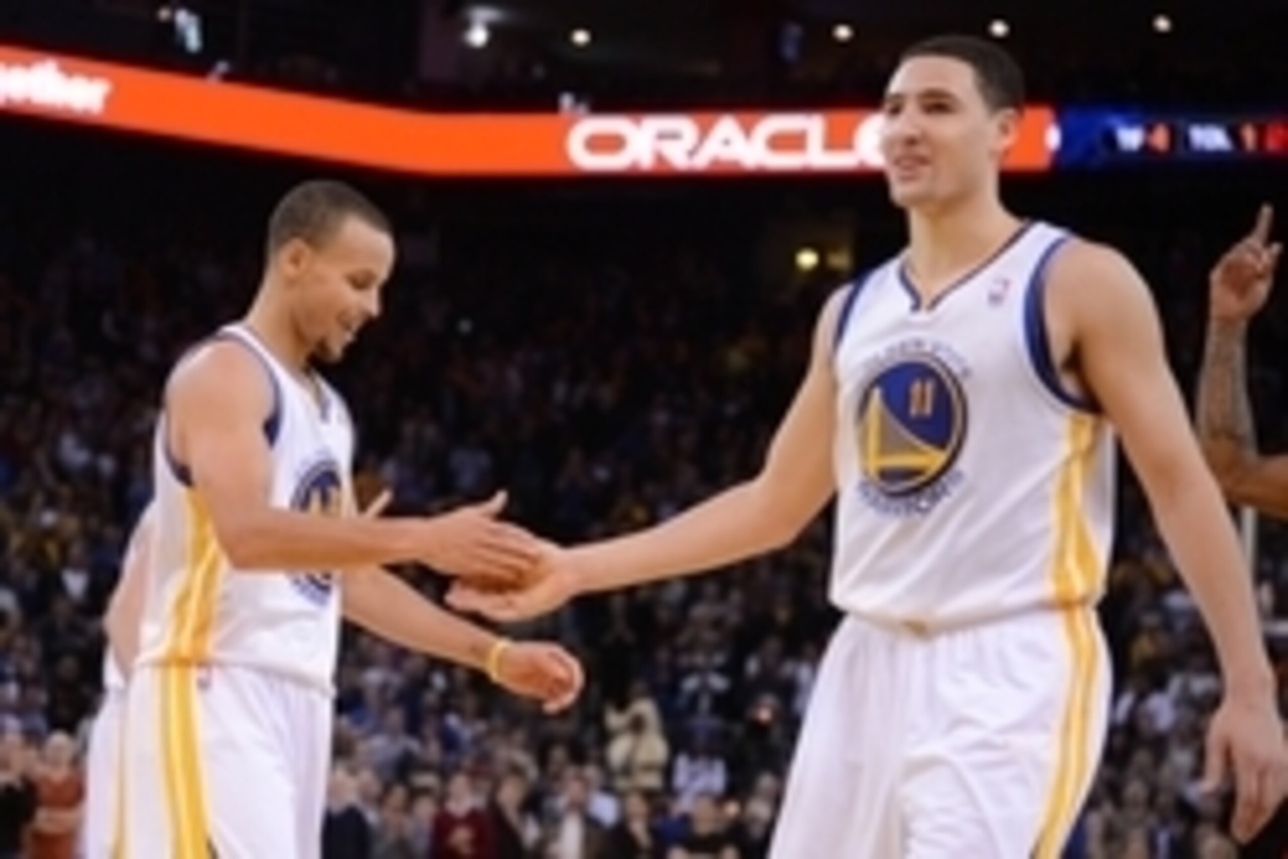 December 3, 2013; Oakland, CA, USA; Golden State Warriors point guard Stephen Curry (30, left) and shooting guard Klay Thompson (11) celebrate during the fourth quarter against the Toronto Raptors at Oracle Arena. The Warriors defeated the Raptors 112-103