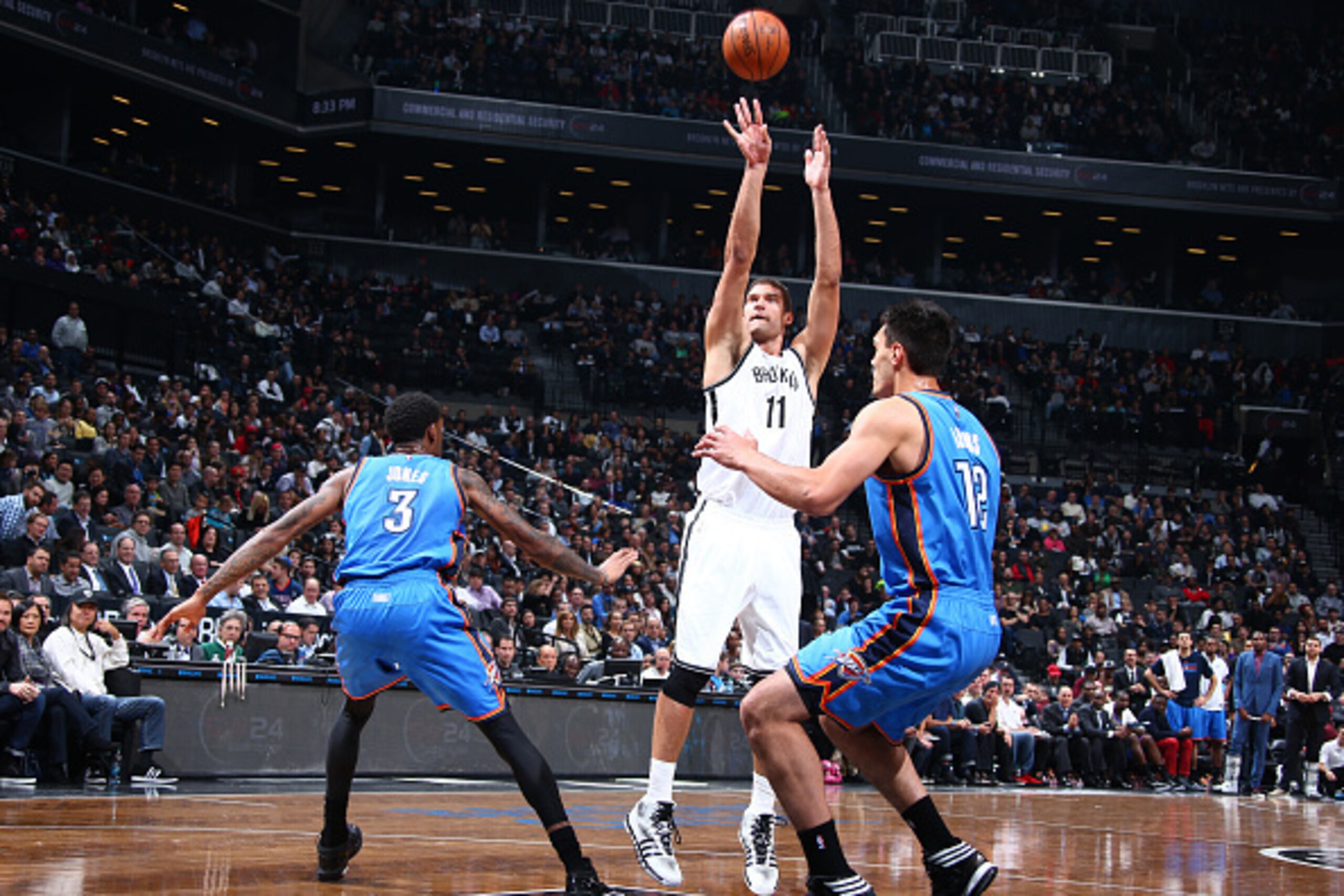 NEW YORK, NY - NOVEMBER 3:  Brook Lopez #11 of the Brooklyn Nets shoots against Perry Jones #3 and Steven Adams #12 of the Oklahoma City Thunder on November 3, 2014 at the Barclays Center in the Brooklyn borough of New York City. NOTE TO USER: User expres