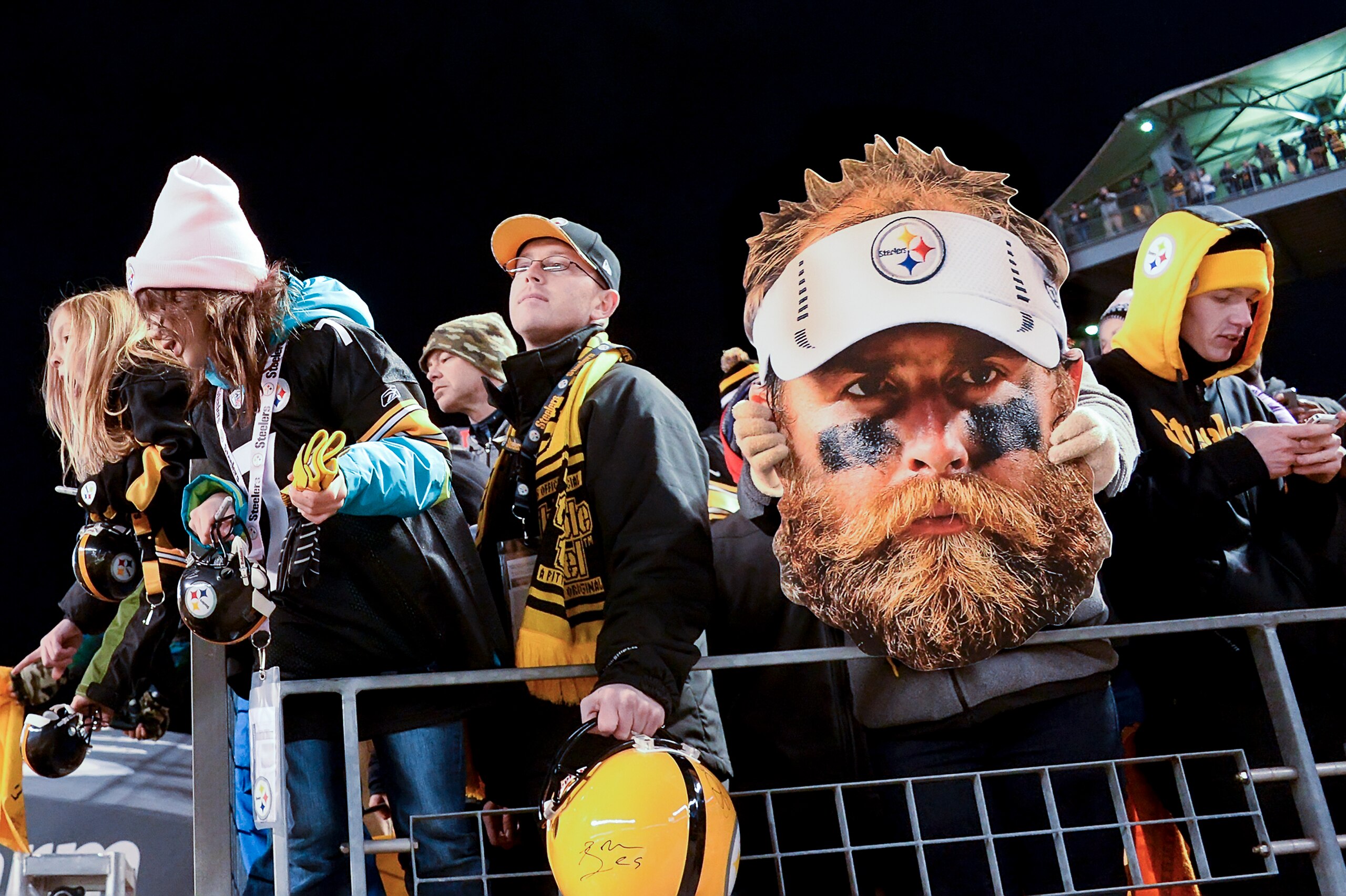 Fans hold up a giant Brett Keisel head in support of their team