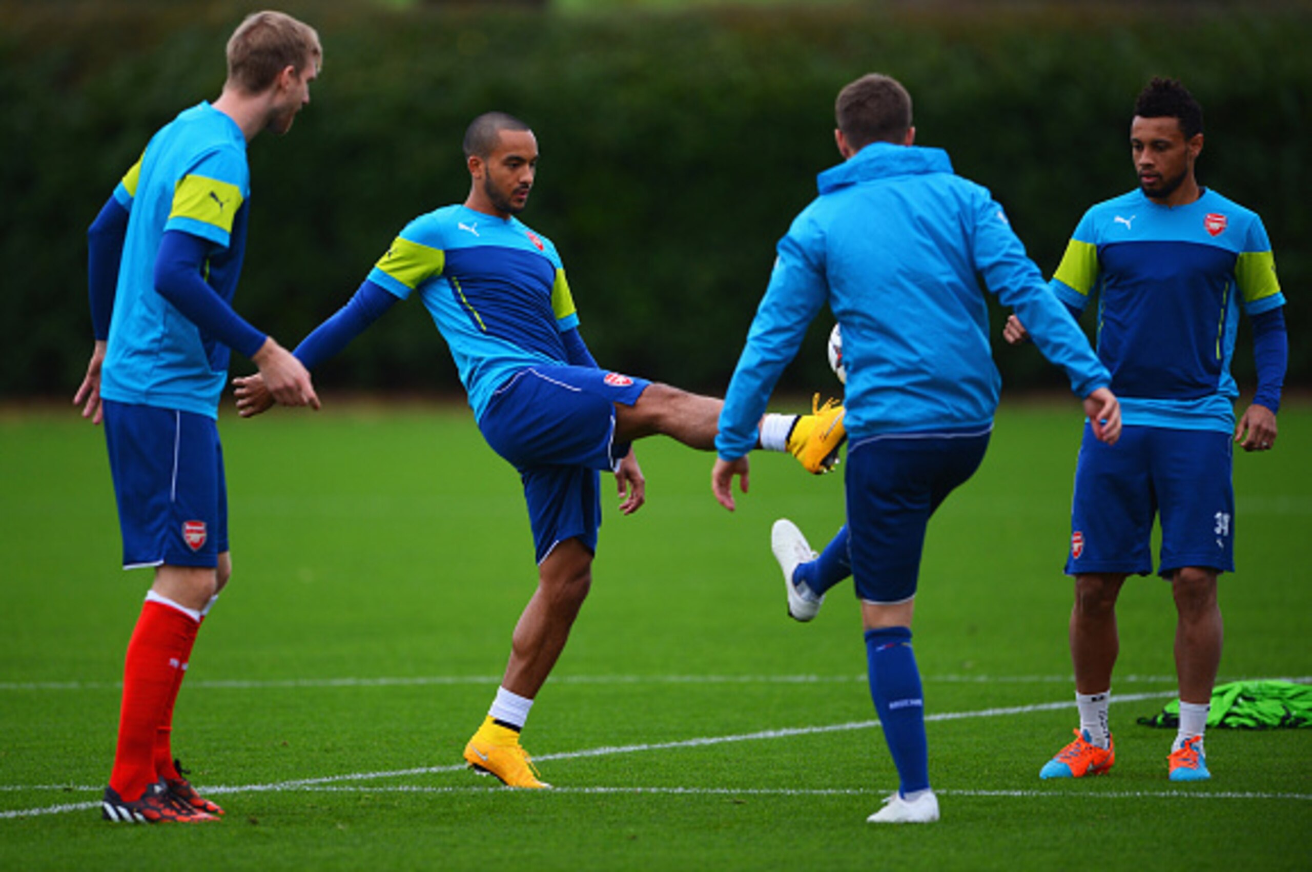 ST ALBANS, ENGLAND - NOVEMBER 03: (L-R) Per Mertesacker, Theo Walcott, Aaron Ramsey and Francis Coquelin during an Arsenal training session ahead of the UEFA Champions League match against RSC Anderlecht at London Colney on November 3, 2014 in St Albans, ST ALBANS, ENGLAND - NOVEMBER 03: (L-R) Per Mertesacker, Theo Walcott, Aaron Ramsey and Francis Coquelin during an Arsenal training session ahead of the UEFA Champions League match against RSC Anderlecht at London Colney on November 3, 2014 in St Albans,