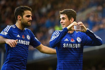 LONDON, ENGLAND - NOVEMBER 01:  Oscar of Chelsea celebrates his goal with Cesc Fabregas during the Barclays Premier League match between Chelsea and Queens Park Rangers at Stamford Bridge on November 1, 2014 in London, England.  (Photo by Mike Hewitt/Gett