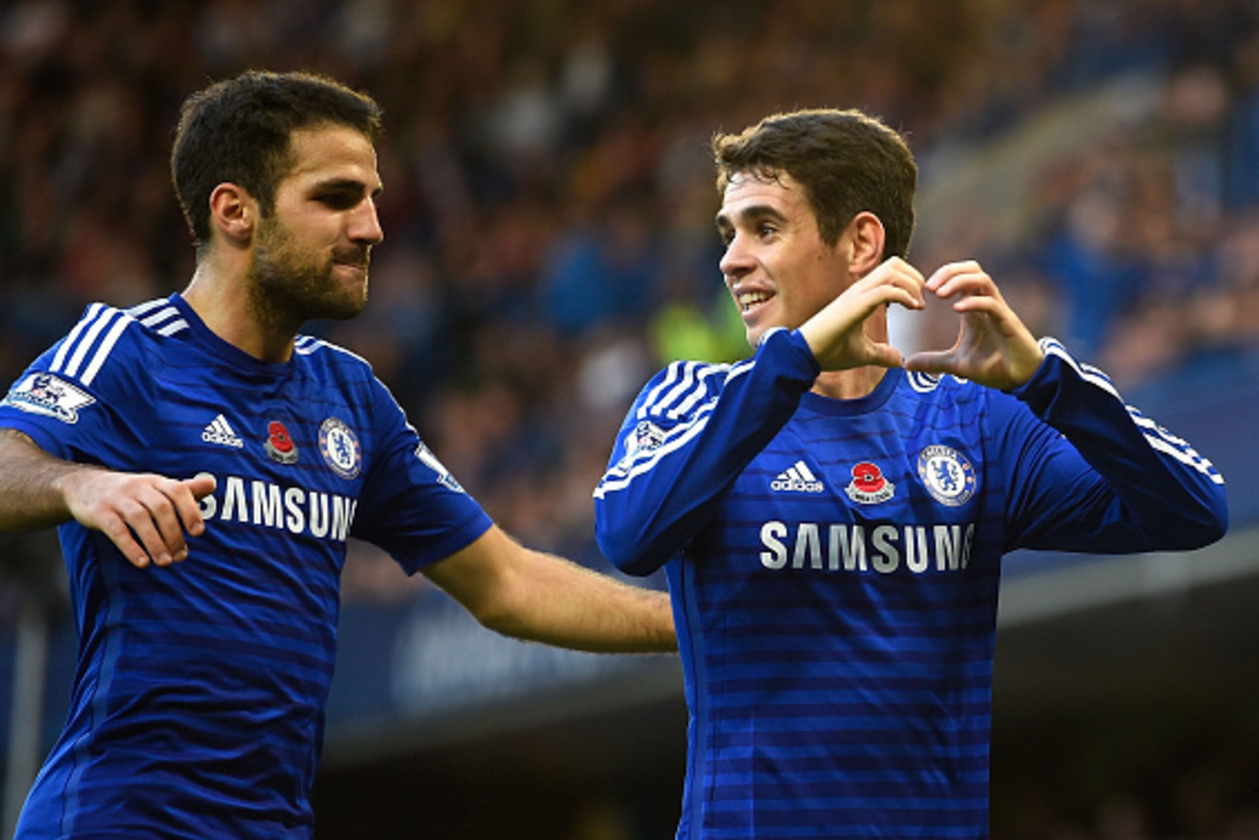 LONDON, ENGLAND - NOVEMBER 01:  Oscar of Chelsea celebrates his goal with Cesc Fabregas during the Barclays Premier League match between Chelsea and Queens Park Rangers at Stamford Bridge on November 1, 2014 in London, England.  (Photo by Mike Hewitt/Gett
