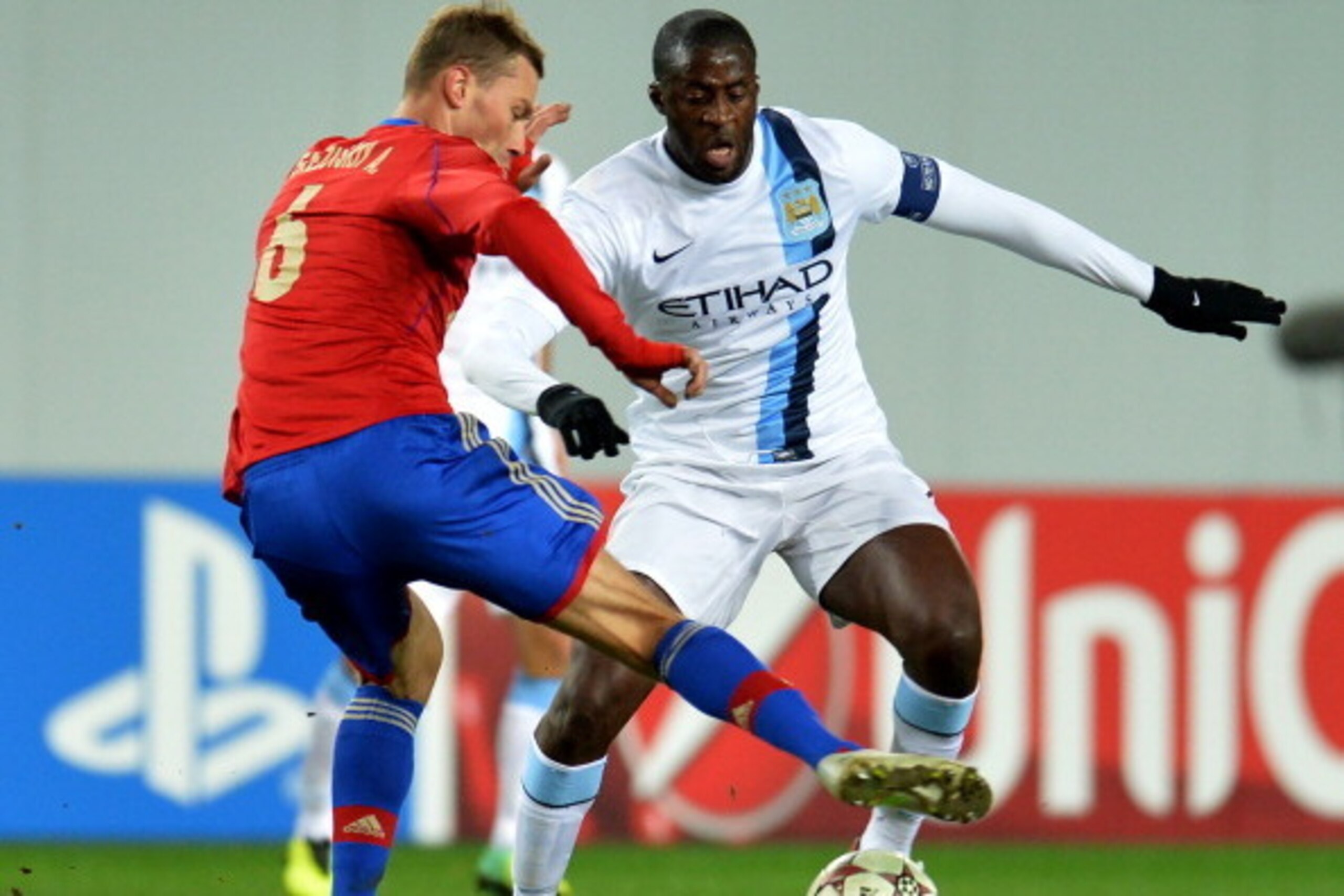 KHIMKI, RUSSIA - OCTOBER 23: Aleksei Berezutski (L) of PFC CSKA Moscow in action against Yaya Toure of Manchester City FC during the UEFA Champions League Group D match between PFC CSKA Moscow and Manchester City FC at the Arena Khimki Stadium on October 