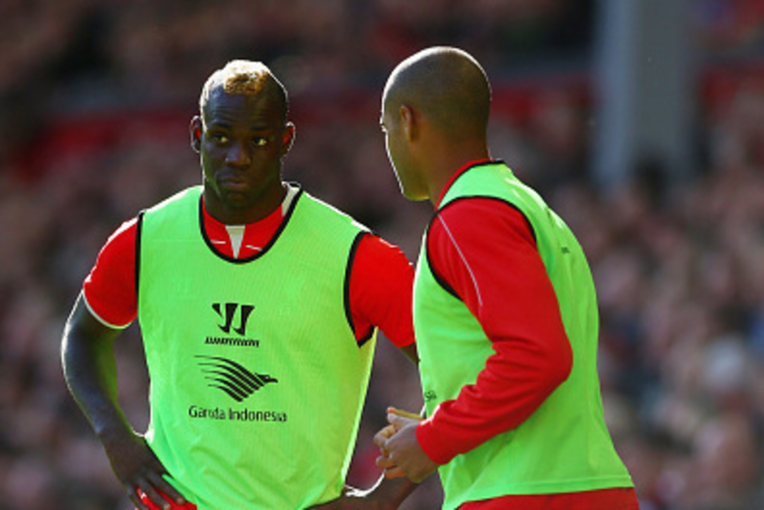 LIVERPOOL, ENGLAND - OCTOBER 04:  Mario Balotelli and Glen Johnson of Liverpool warm up on the touchline during the Barclays Premier League match between Liverpool and West Bromwich Albion at Anfield on October 4, 2014 in Liverpool, England.  (Photo by Cl
