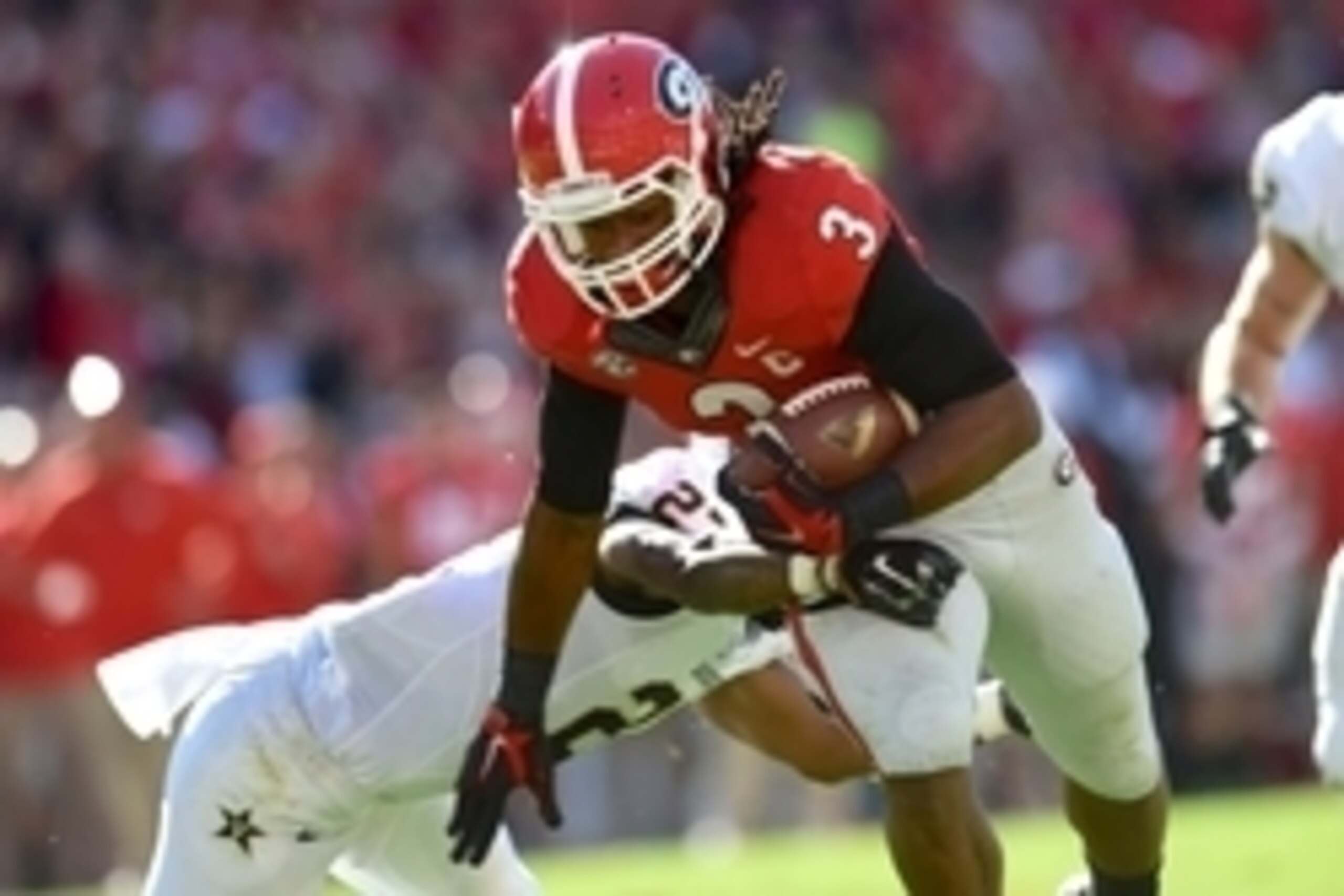 Oct 4, 2014; Athens, GA, USA; Georgia Bulldogs running back Todd Gurley (3) breaks a tackle by Vanderbilt Commodores safety Jahmel McIntosh (27) on his way to a touchdown during the first quarter at Sanford Stadium. Mandatory Credit: Dale Zanine-USA TODAY