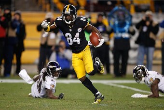 PITTSBURGH, PA - NOVEMBER 02:  Antonio Brown #84 of the Pittsburgh Steelers avoids a tackle by Lardarius Webb #21 and Will Hill #33 of the Baltimore Ravens and scores a 54 yard touchdown during the fourth quarter at Heinz Field on November 2, 2014 in Pitt