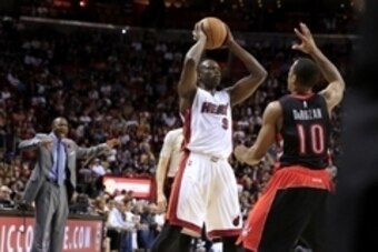 Nov 2, 2014; Miami, FL, USA;  Miami Heat forward Luol Deng (9) looks to pass while defended by Toronto Raptors guard DeMar DeRozan (10) in the second half at American Airlines Arena. The Heat won107-102. Mandatory Credit: Robert Mayer-USA TODAY Sports