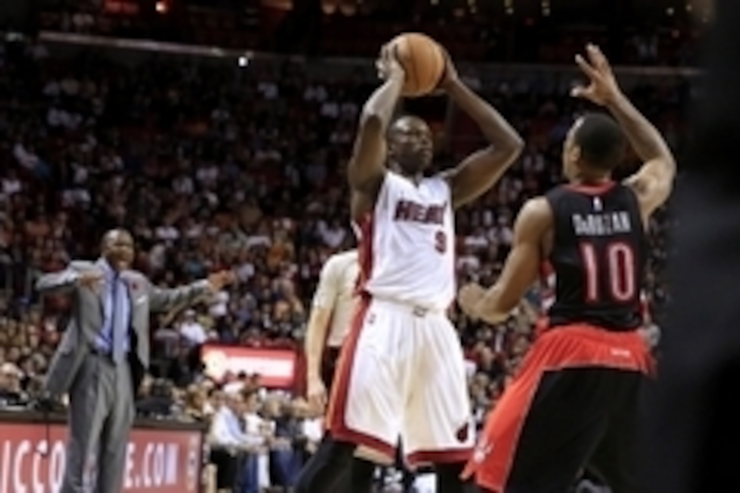 Nov 2, 2014; Miami, FL, USA;  Miami Heat forward Luol Deng (9) looks to pass while defended by Toronto Raptors guard DeMar DeRozan (10) in the second half at American Airlines Arena. The Heat won107-102. Mandatory Credit: Robert Mayer-USA TODAY Sports