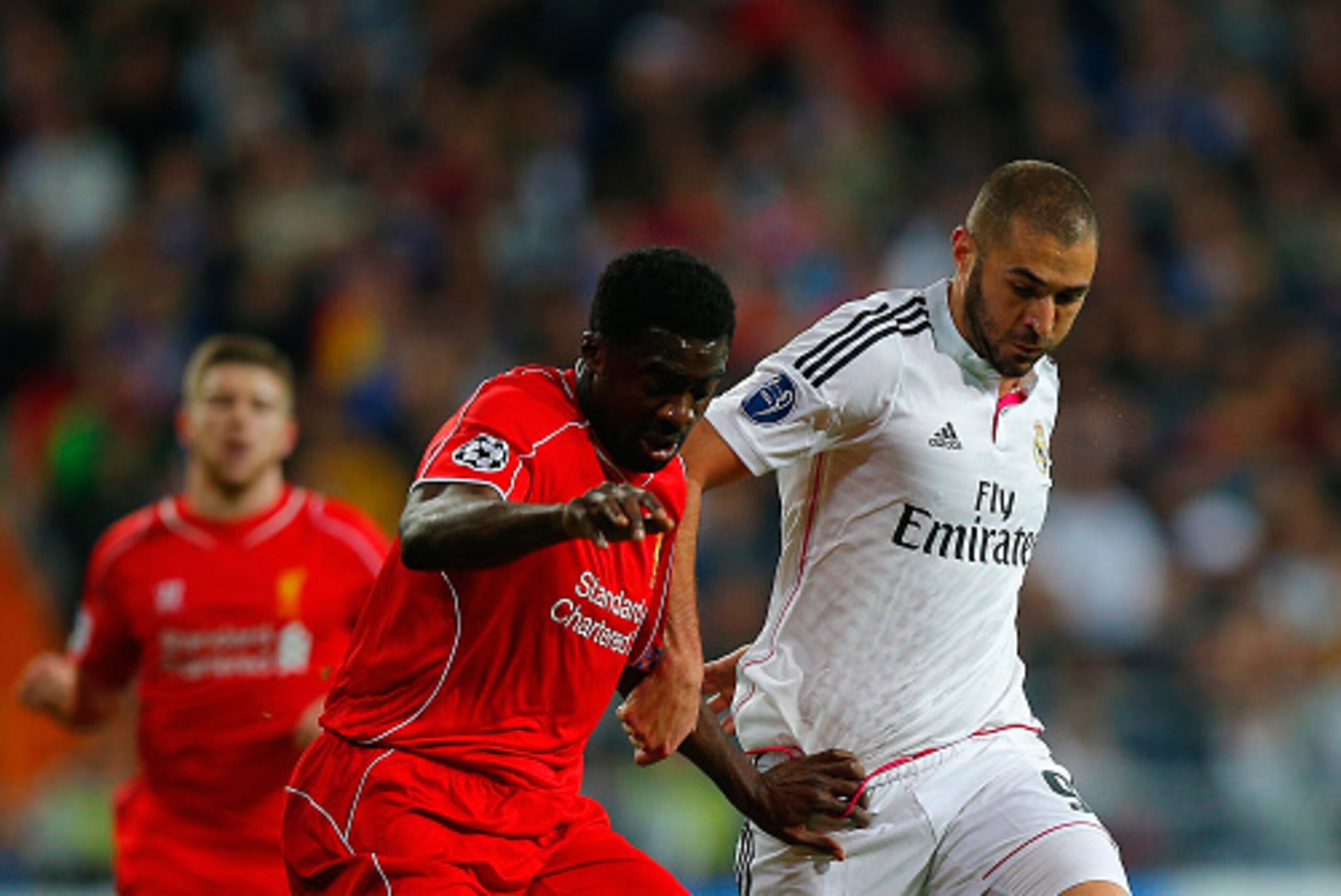 MADRID, SPAIN - NOVEMBER 04: Kolo Toure of Liverpool and Karim Benzema of Real Madrid CF battle for the ball during the UEFA Champions League Group B match between Real Madrid CF and Liverpool FC at Estadio Santiago Bernabeu on November 4, 2014 in Madrid,