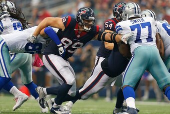 ARLINGTON, TX - OCTOBER 05:  J.J. Watt #99 of the Houston Texans breaks through the line of scrimmage against the Dallas Cowboys in the second half at AT&T Stadium on October 5, 2014 in Arlington, Texas.  (Photo by Tom Pennington/Getty Images)