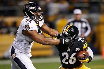 PITTSBURGH, PA - NOVEMBER 02:  Le'Veon Bell #26 of the Pittsburgh Steelers tries to break a tackle by Daryl Smith #51 of the Baltimore Ravens during the first quarter at Heinz Field on November 2, 2014 in Pittsburgh, Pennsylvania.  (Photo by Gregory Shamu