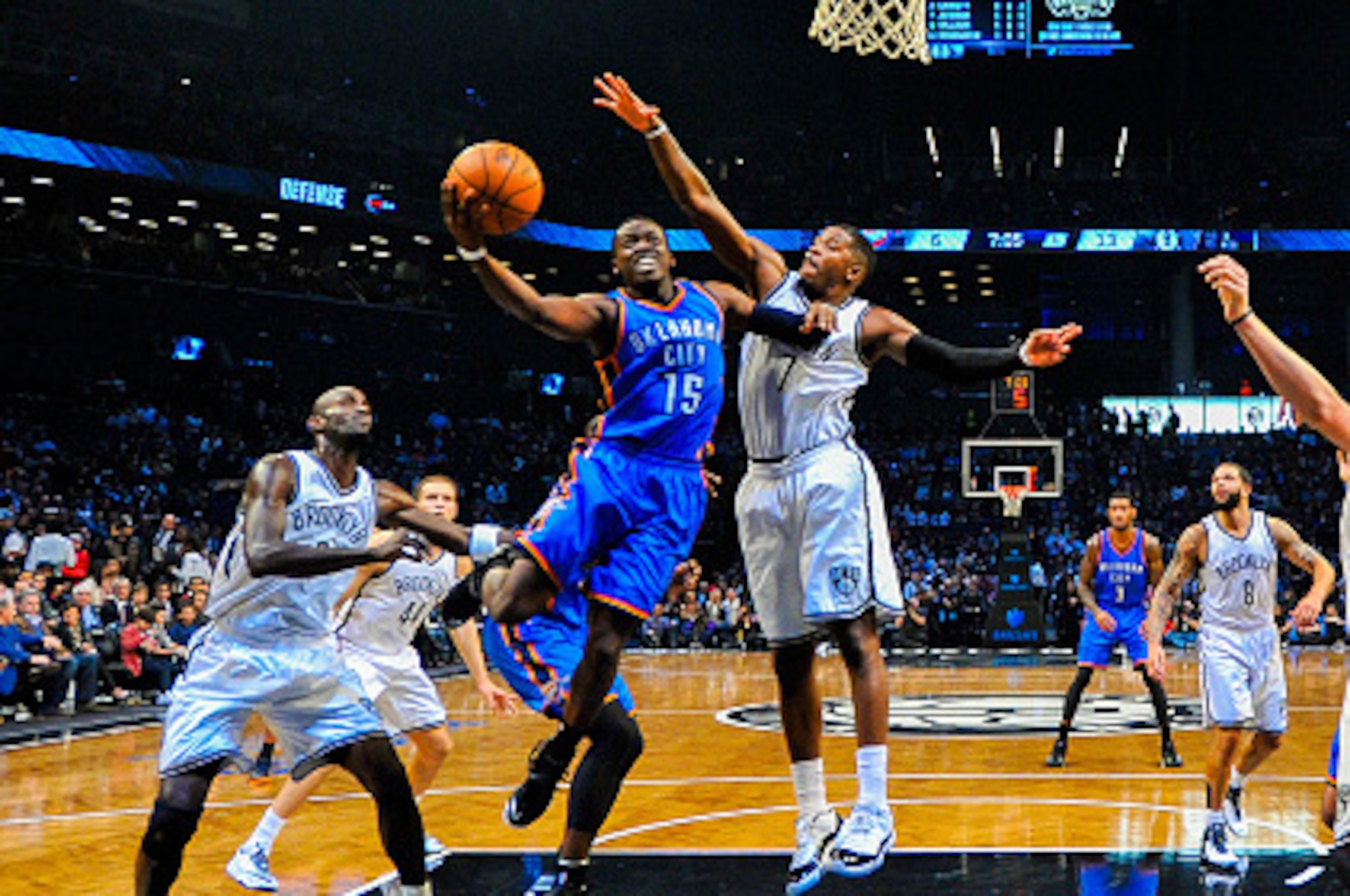 NEW YORK, NY - NOVEMBER 03: Reggie Jackson #15 of the Oklahoma City Thunder attempts a shot over Joe Johnson #7 of the Brooklyn Nets in the first half at the Barclays Center on November 3, 2014 in the Brooklyn borough of New York City. NOTE TO USER: User 