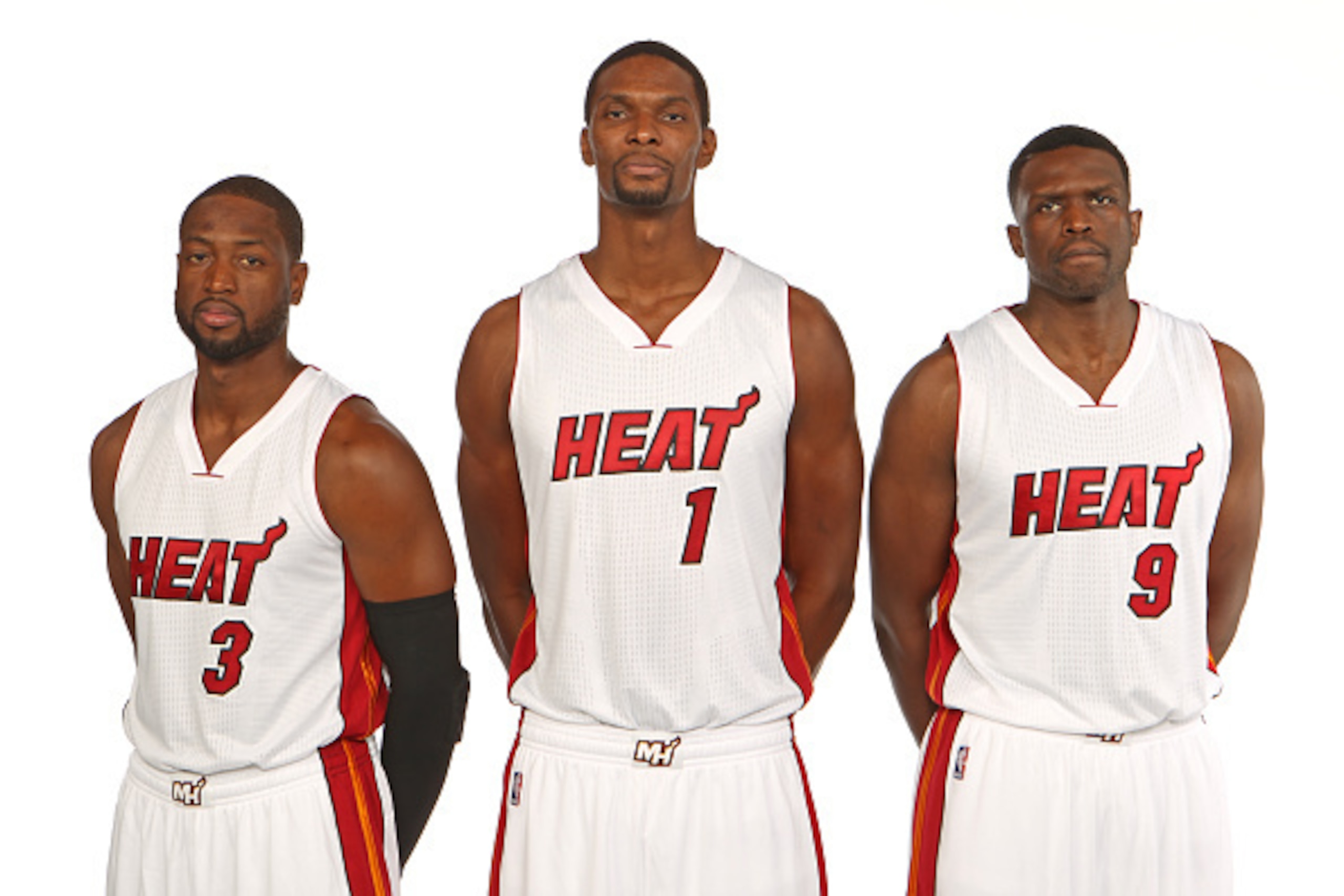 MIAMI, FL - SEPTEMBER 26: Dwyane Wade #3, Chris Bosh #1, and Luol Deng #9 of the Miami Heat pose for a portrait during 2014 Media Day at the America Airlines Arena in Miami, Florida. NOTE TO USER: User expressly acknowledges and agrees that, by downloadin