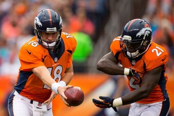 DENVER, CO - AUGUST 24: Quarterback Peyton Manning #18 of the Denver Broncos hands the ball off to running back Ronnie Hillman #21 against the St. Louis Rams at Sports Authority Field at Mile High on August 24, 2013 in Denver, Colorado. (Photo by Justin E