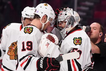 MONTREAL, QC - NOVEMBER 4: Teammates of the Chicago Blackhawks celebrate the victory with the goalkeeper Corey Crawford #50 against the Montreal Canadiens in the NHL game at the Bell Centre on November 4, 2014 in Montreal, Quebec, Canada. (Photo by Franco