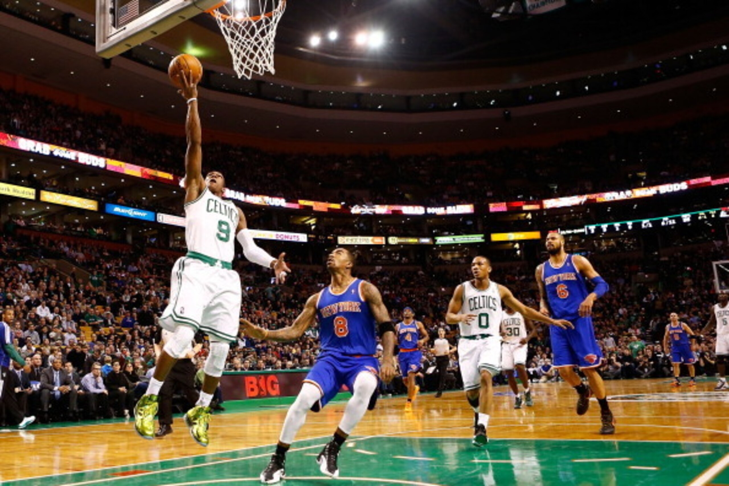 BOSTON, MA - JANUARY 24:  Rajon Rondo #9 of the Boston Celtics goes up for a layup in front of J.R. Smith #8 of the New York Knicks during the game on January 24, 2013 at TD Garden in Boston, Massachusetts. NOTE TO USER: User expressly acknowledges and ag