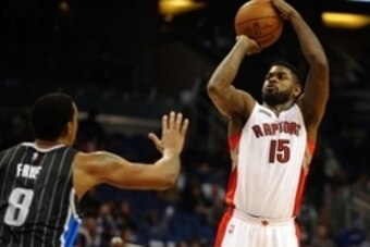 Nov 1, 2014; Orlando, FL, USA; Toronto Raptors forward Amir Johnson (15) shoots over Orlando Magic forward Channing Frye (8) in the first half at Amway Center. Mandatory Credit: David Manning-USA TODAY Sports