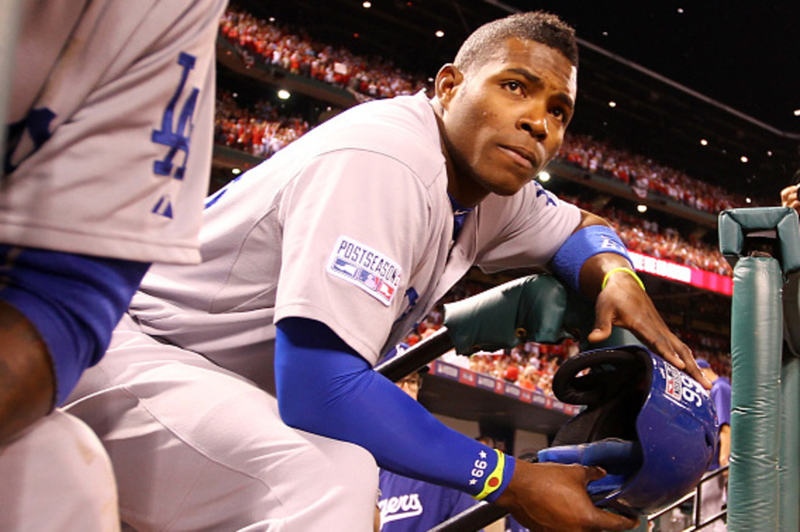 ST LOUIS, MO - OCTOBER 07:  Yasiel Puig #66 of the Los Angeles Dodgers looks on from the dugout steps after being defeated by the St. Louis Cardinals in Game Four of the National League Divison Series at Busch Stadium on October 7, 2014 in St Louis, Misso