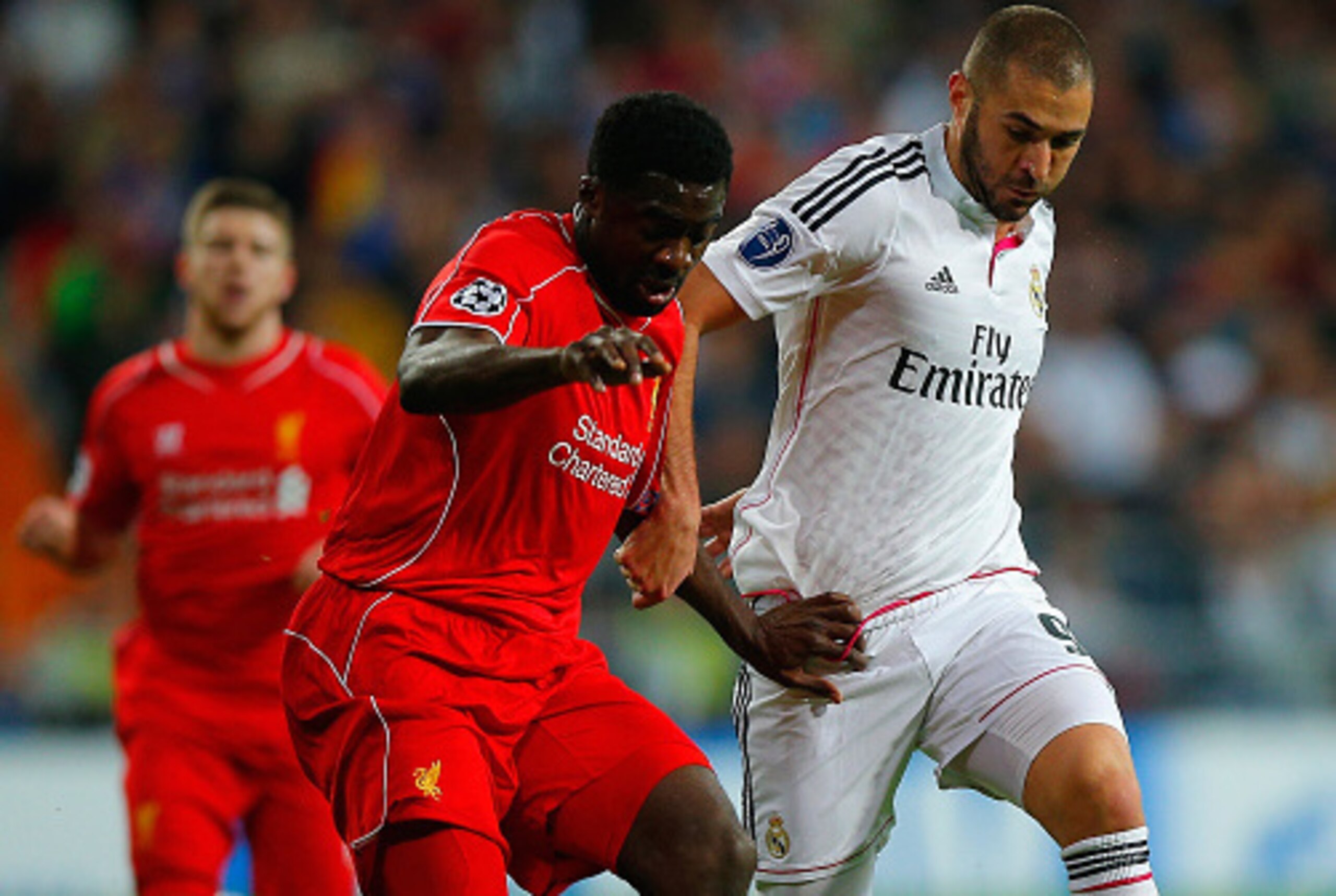 MADRID, SPAIN - NOVEMBER 04: Kolo Toure of Liverpool and Karim Benzema of Real Madrid CF battle for the ball during the UEFA Champions League Group B match between Real Madrid CF and Liverpool FC at Estadio Santiago Bernabeu on November 4, 2014 in Madrid,