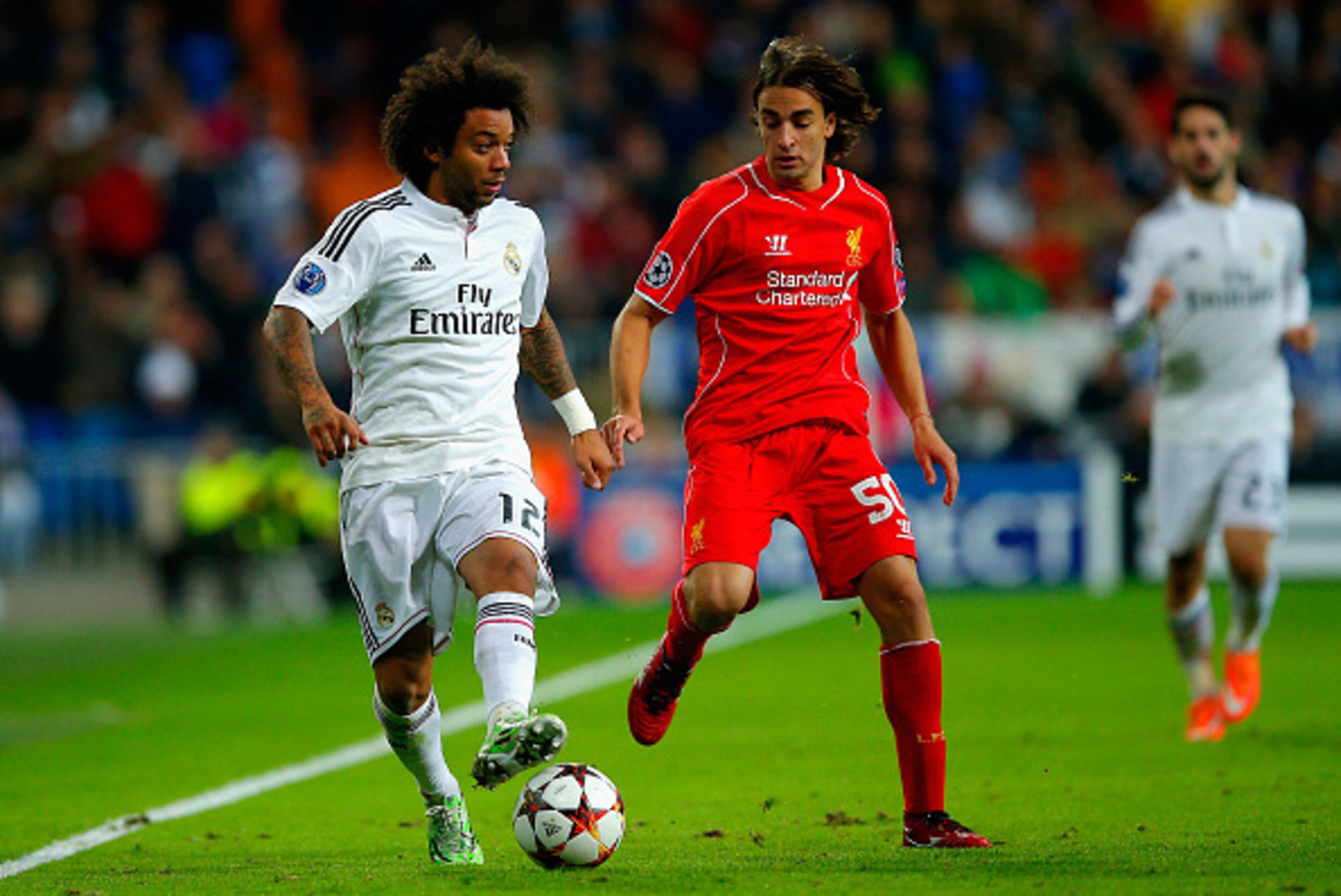 MADRID, SPAIN - NOVEMBER 04:  Marcelo of Real Madrid CF is closed down by Lazar Markovic of Liverpool during the UEFA Champions League Group B match between Real Madrid CF and Liverpool FC at Estadio Santiago Bernabeu on November 4, 2014 in Madrid, Spain.