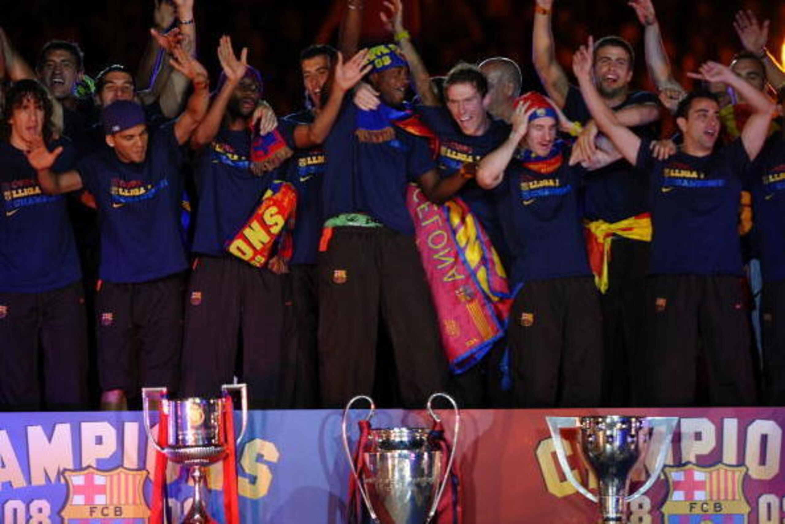 BARCELONA, SPAIN - MAY 28: Barcelona players celebrate beside their three thophys, Copa del Rey (L), UEFA Champions League and La Liga at the Nou Camp Stadium the day after Barcelona won the UEFA Champions League Cup final on May 28, 2009 in Barcelona, Sp