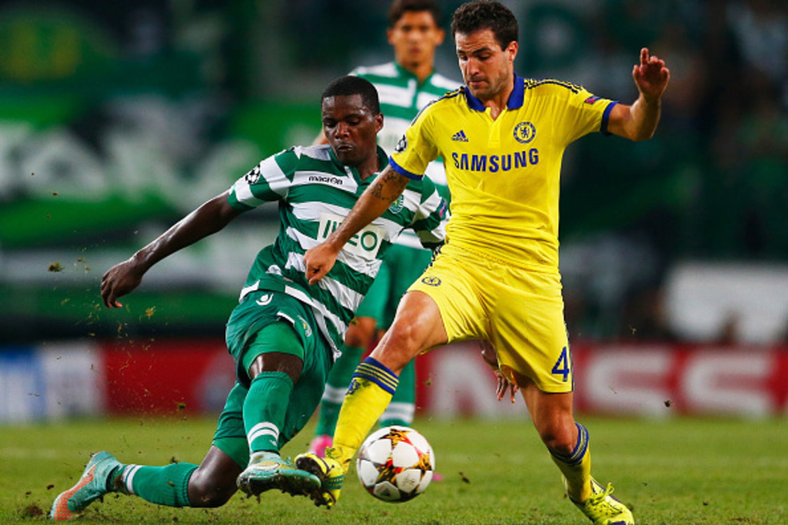 LISBON, PORTUGAL - SEPTEMBER 30:  William Carvalho of Sporting Lisbon tackles Cesc Fabregas of Chelsea during the UEFA Champions League Group G match between Sporting Clube de Portugal and Chelsea FC at Estadio Jose Alvalade on September 30, 2014 in Lisbo