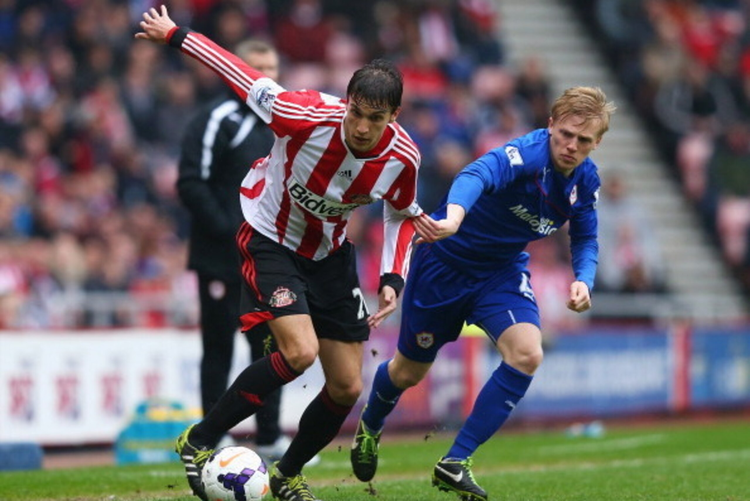 SUNDERLAND, ENGLAND - APRIL 27: Santiago Vergini of Sunderland is closed down by Mats Moller Daehli of Cardiff City during the Barclays Premier League match between Sunderland and Cardiff City at the Stadium of Light on April 27, 2014 in Sunderland, Engla