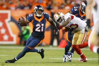 Oct 19, 2014; Denver, CO, USA; Denver Broncos cornerback Aqib Talib (21) intercepts a pass intended for San Francisco 49ers wide receiver Steve Johnson (13) in the third quarter at Sports Authority Field at Mile High. Mandatory Credit: Chris Humphreys-USA
