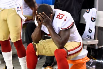 Oct 19, 2014; Denver, CO, USA; San Francisco 49ers running back Frank Gore (21) reacts on the bench late in the fourth quarter against the Denver Broncos at Sports Authority Field at Mile High. The Broncos defeated the 49ers 42-17. Mandatory Credit: Ron C