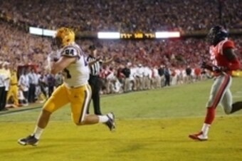 Oct 25, 2014; Baton Rouge, LA, USA; LSU Tigers tight end Logan Stokes (84) runs into the end zone in front of Mississippi Rebels defensive back Senquez Golson (21) for a touchdown in the fourth quarter at Tiger Stadium. Mandatory Credit: Crystal LoGiudice