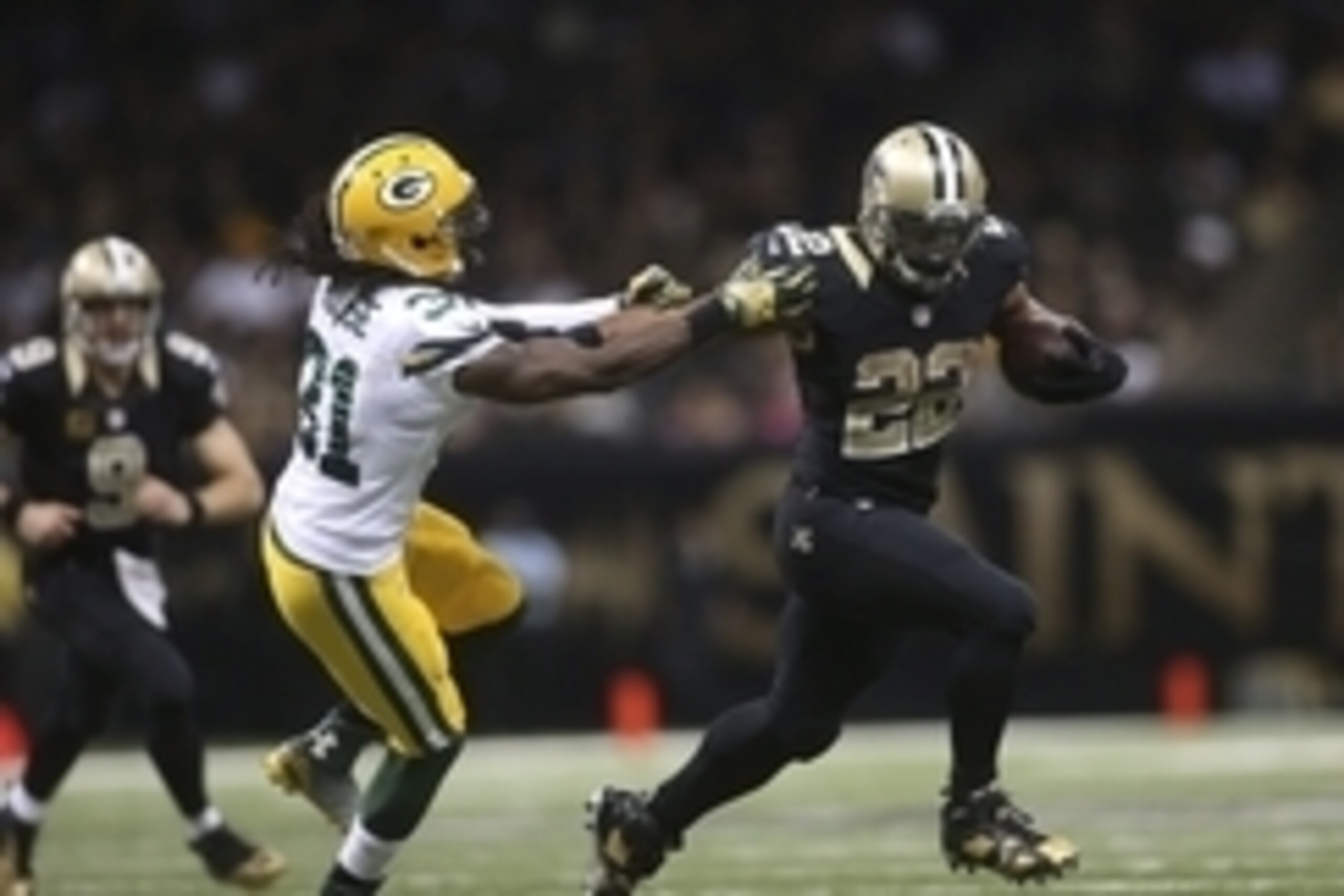 Oct 26, 2014; New Orleans, LA, USA; New Orleans Saints running back Mark Ingram (22) fights off Green Bay Packers cornerback Davon House (31) as he carries the ball in the second half at Mercedes-Benz Superdome. New Orleans defeated Green Bay 44-23. Manda